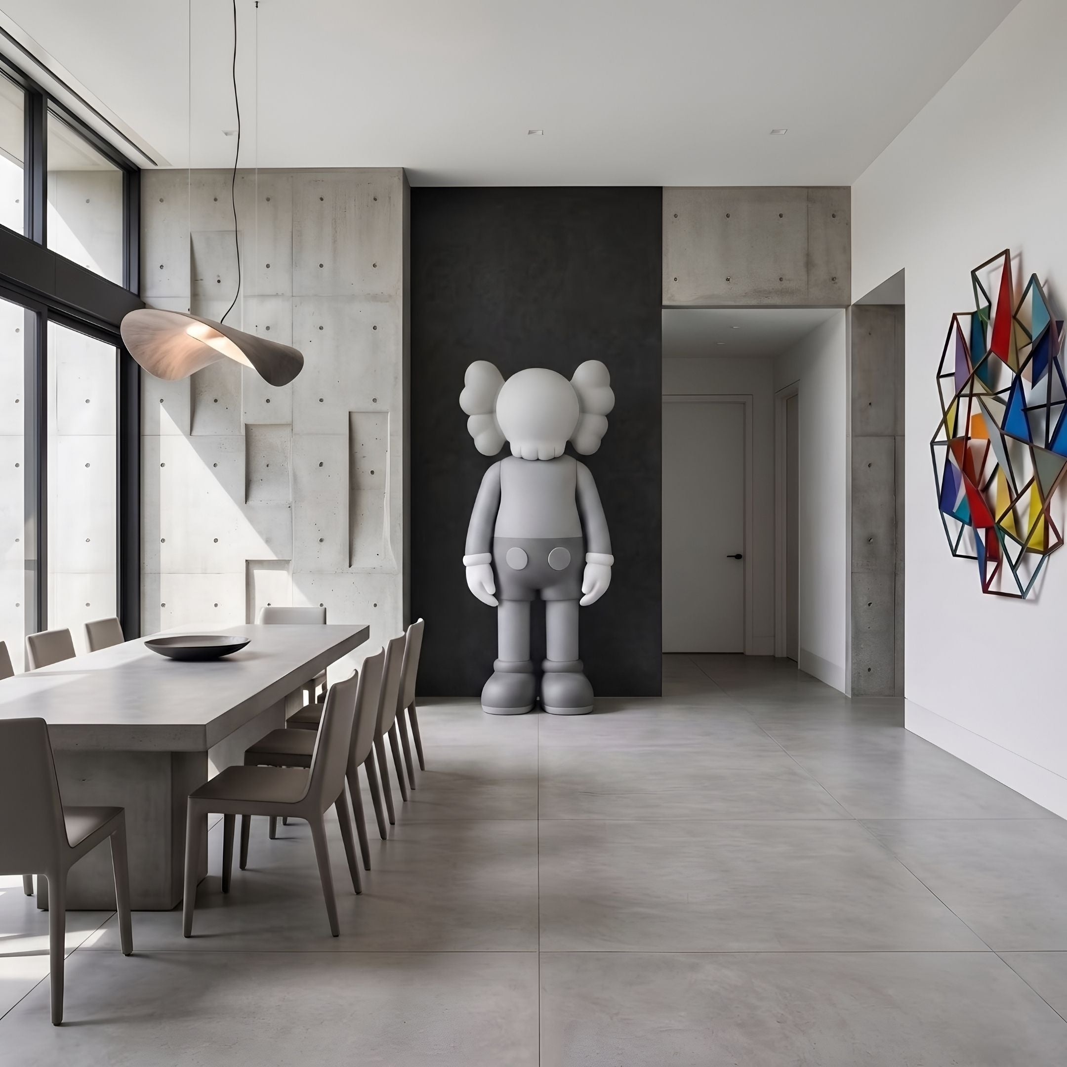 Soft Grey Iconify Standing Sculpture, 220cm, by Giant Sculptures, shown in a dining room against a dark accent wall near concrete panels and a long table.