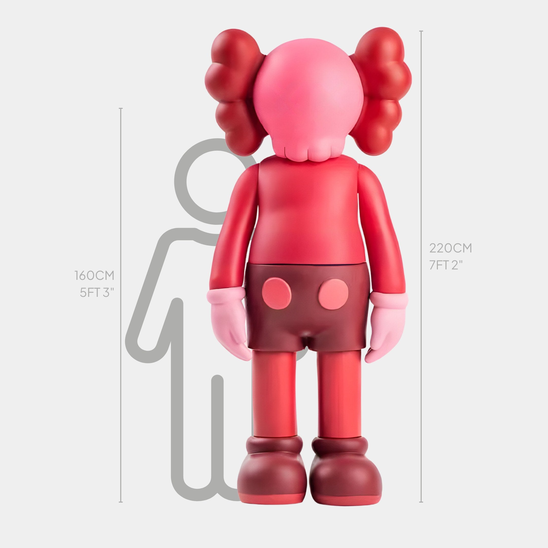 The Blush Ruby Iconify Standing Sculpture by Giant Sculptures features a cartoonish, human-like design with red and blush ruby colors, standing at 220 cm (7 ft 2 in). Perfectly fits modern interiors with background silhouettes showcasing various heights.