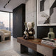 Hazelnut Brown Iconify Hollow Figure - 23cm displayed on a wooden console table, seated with bowed head and clasped hands, beside books and a vase in a modern living room.