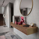 Blush Ruby Iconify Anatomy Figure, 23cm, seated pink and ruby-red collectible sculpture styled on a walnut floating console beneath a round gold mirror.