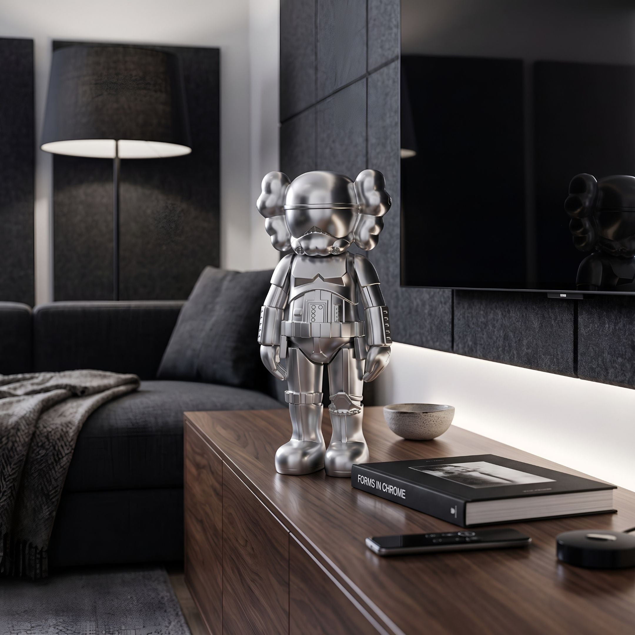 Polished Chrome Silver Iconify Enforcer Figure, 26cm, on a walnut console table in a modern living room with a dark sofa and floor lamp.