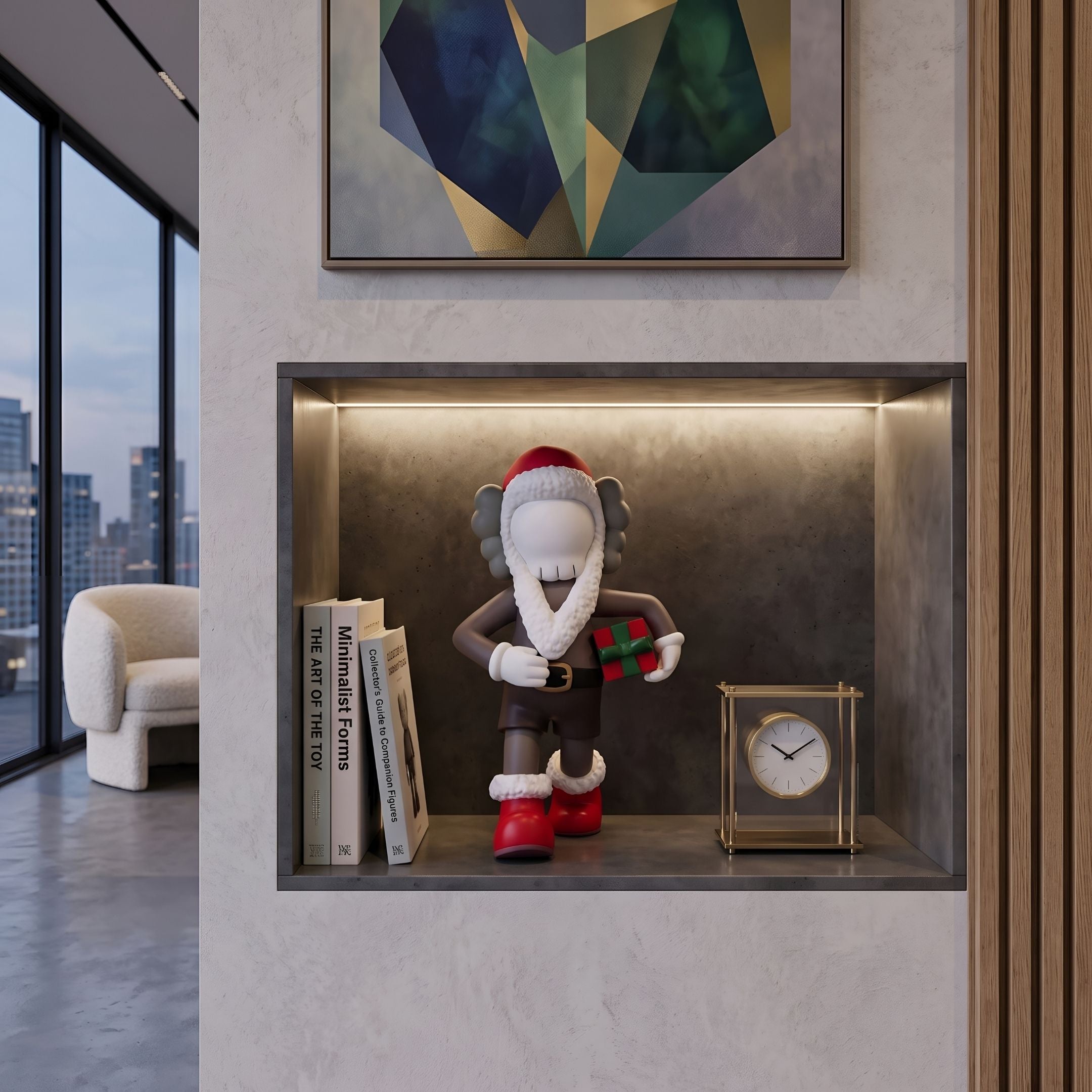 Iconify Christmas Figure - 28cm by Giant Sculptures displayed in a wall niche with a wrapped gift, gold clock, and stacked books beside a living room seating area.