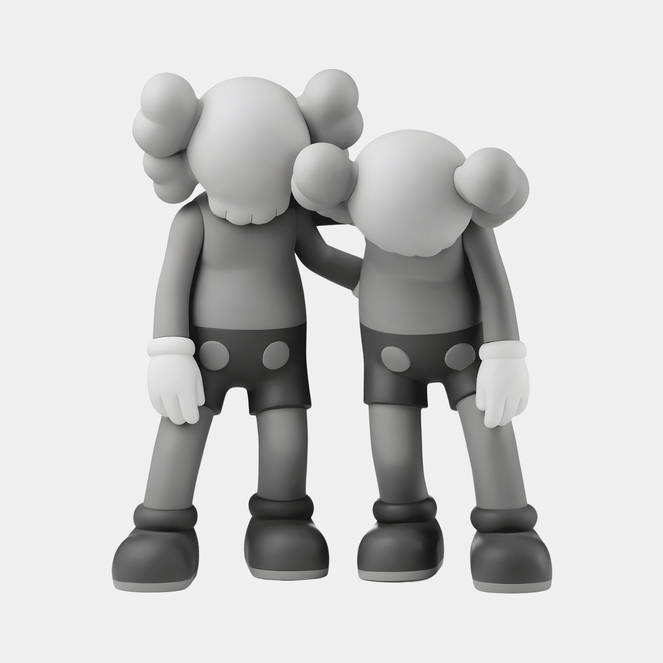 The Giant Sculptures Slate Grey Iconify Friendship Figure - 28cm features two gray cartoonish resin figures with X-shaped eyes and large gloved hands. The left figure places a hand on its slouching companion’s shoulder, symbolizing camaraderie.