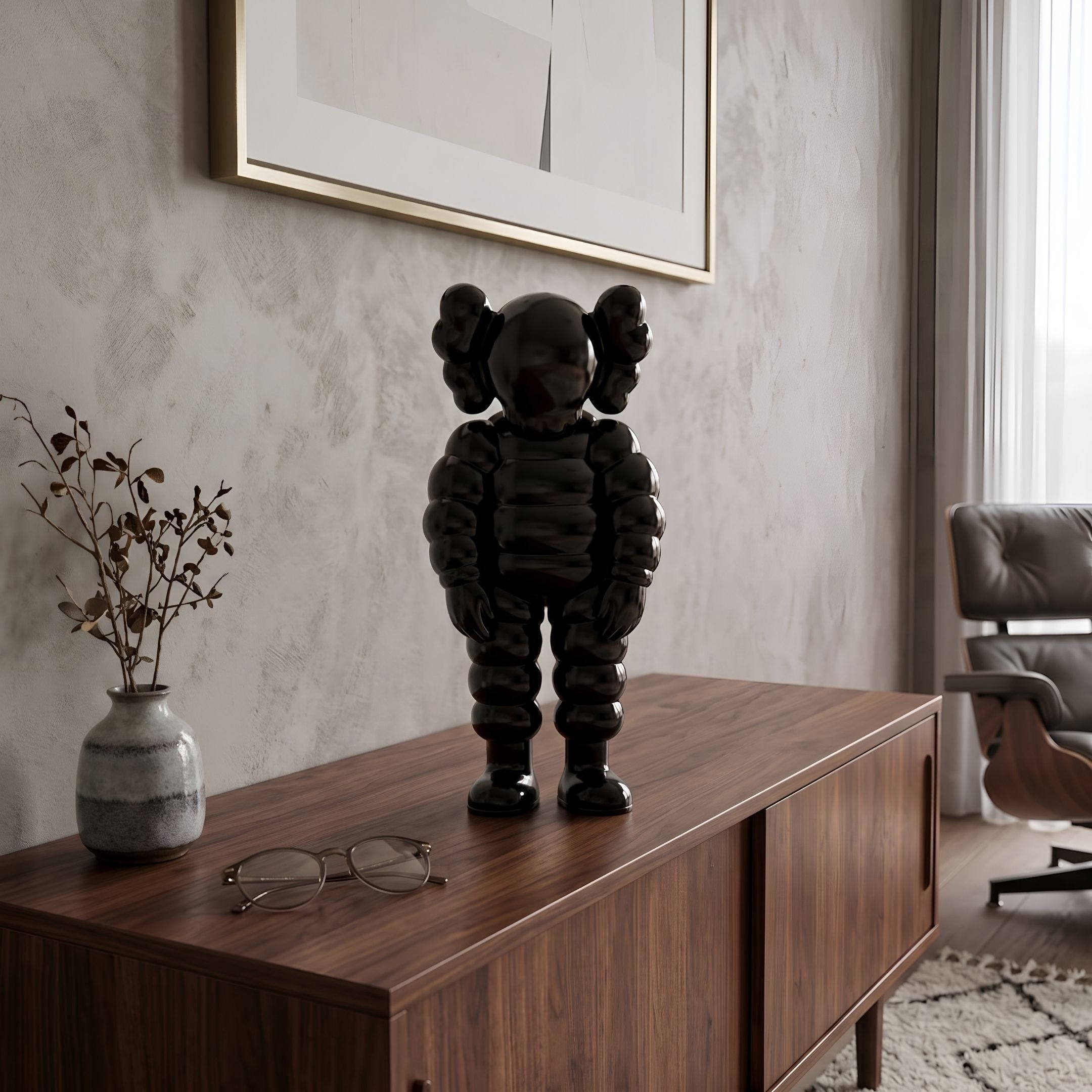 Midnight Black Iconify Rollo Figure, 28cm, glossy black segmented sculpture on a walnut sideboard beside a vase and eyeglasses in a living room.