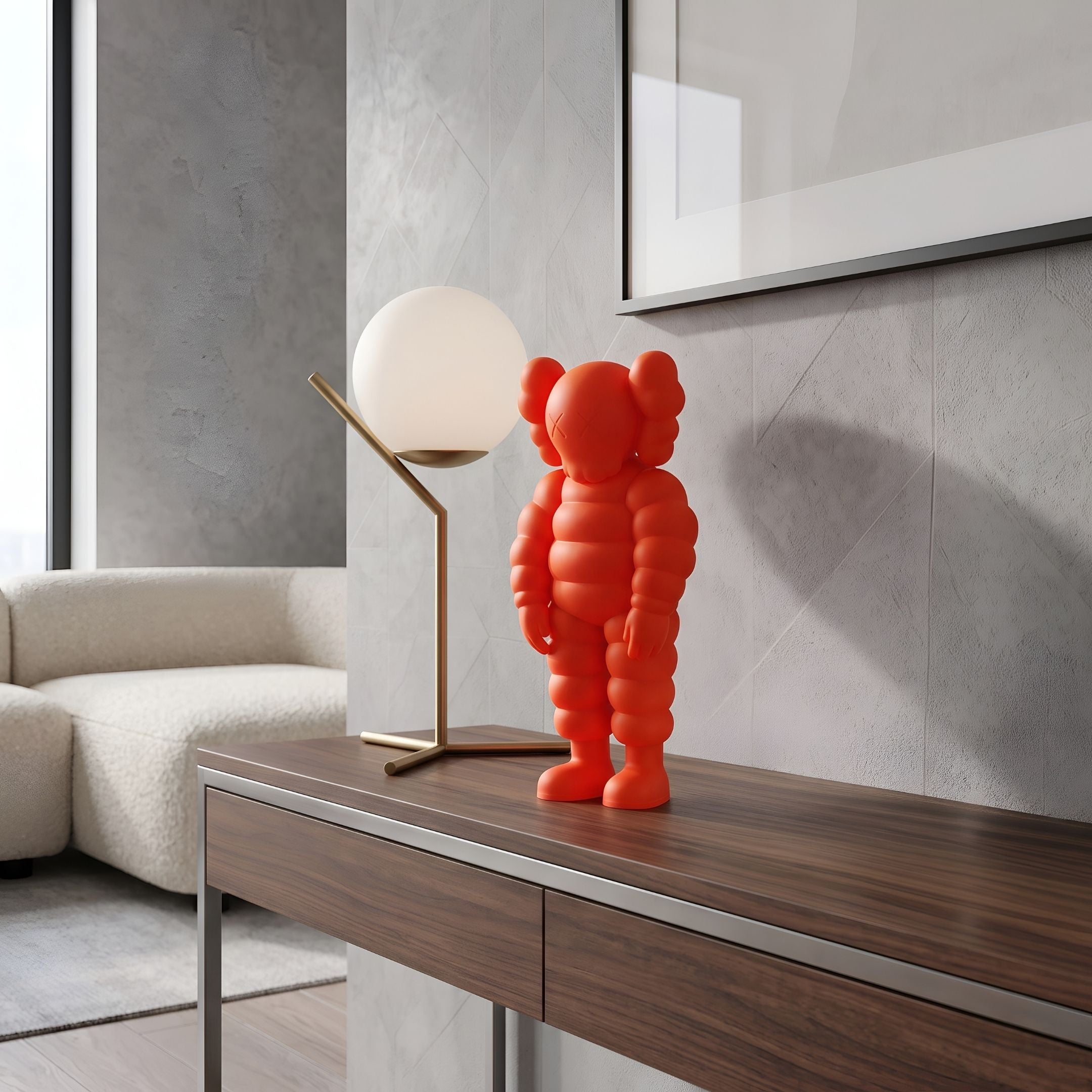 Fiery Orange Iconify Rollo Figure, 28cm, on a wooden console table beside a globe lamp in a modern living room with a beige sofa.