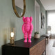 Electric Pink Iconify Rollo Figure, 28cm, displayed on a black sideboard beneath a round brass mirror in a hallway setting.