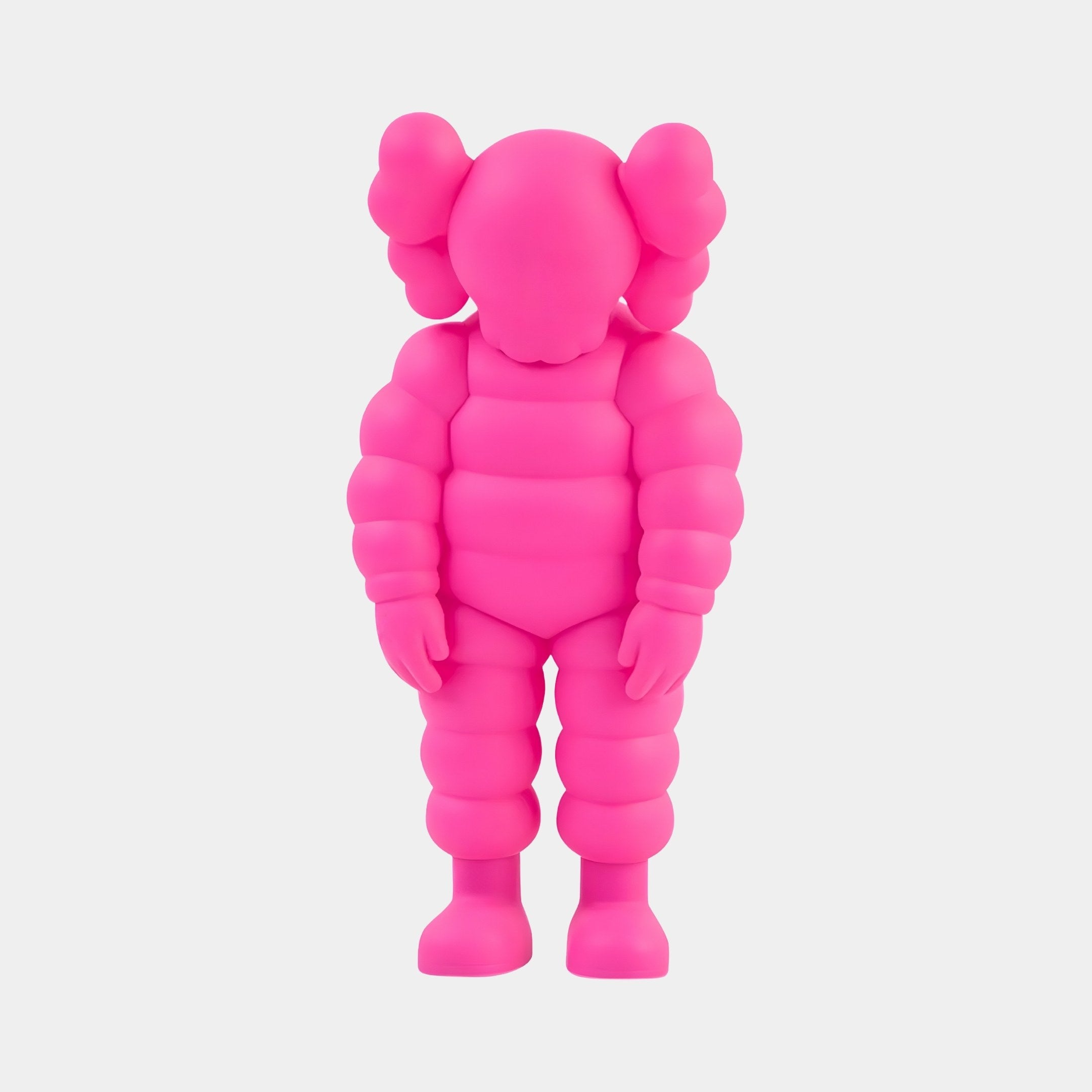 The Electric Pink Iconify Rollo Figure by Giant Sculptures, standing 28cm tall, is perfect for contemporary interiors. It features a cartoonish design with exaggerated limbs, large round ears, and a featureless face on a plain white background, showcasing its balloon-like texture as modern artistry.