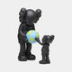 Two cartoon-like figures with large, round heads and X eyes stand together. The taller one hands a small globe to the shorter one. Both obsidian black figures from Giant Sculptures Iconify Atlas Figure collection are set against a plain white background.