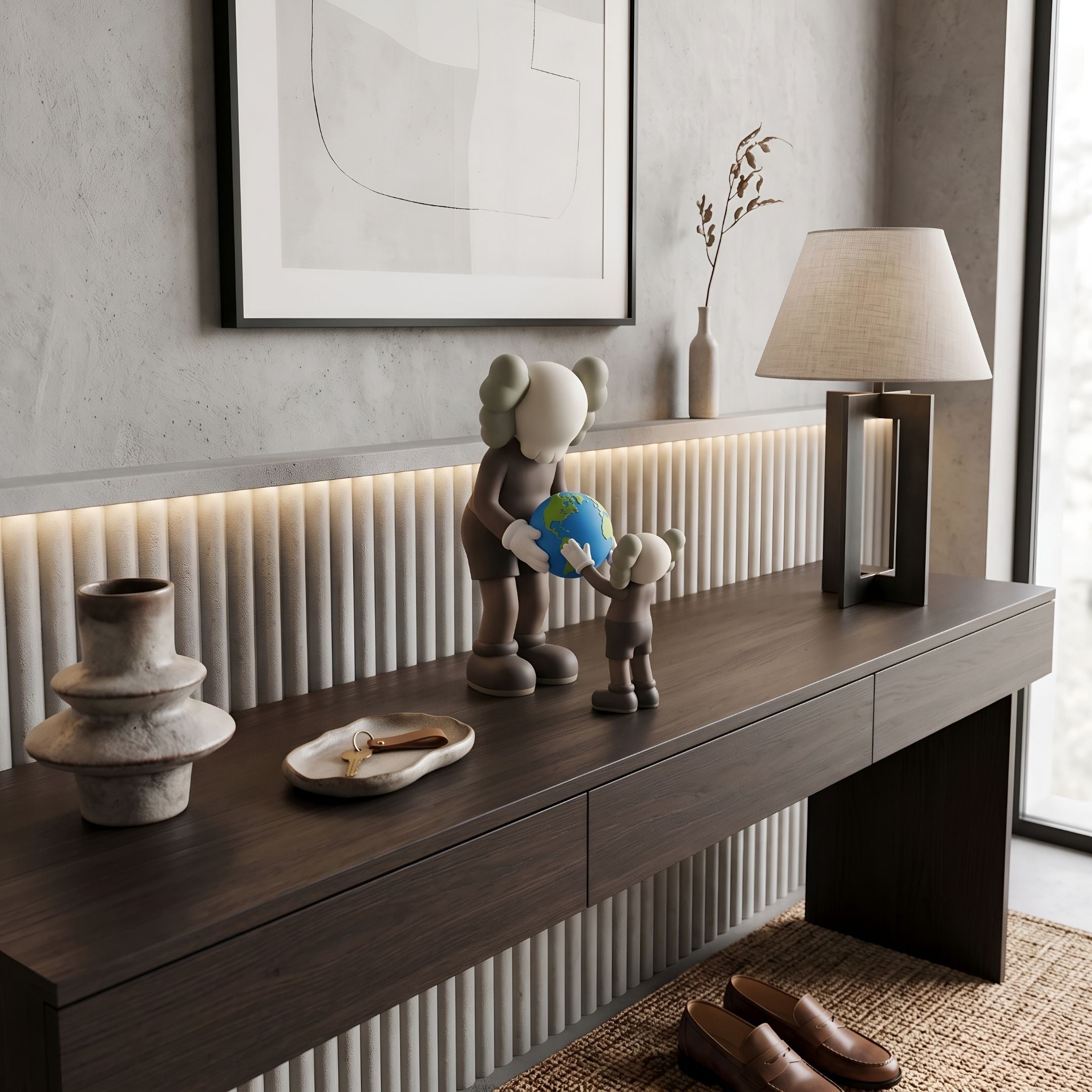 Hazelnut Brown Iconify Atlas Figure - 30cm, two brown figures with white gloves and a colorful globe, displayed on a dark console table in an entryway setting.
