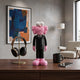 Midnight Black Iconify CEO Figure, 30cm, pink furry-textured character in a black suit, displayed on a wooden desk beside headphones and a lamp.