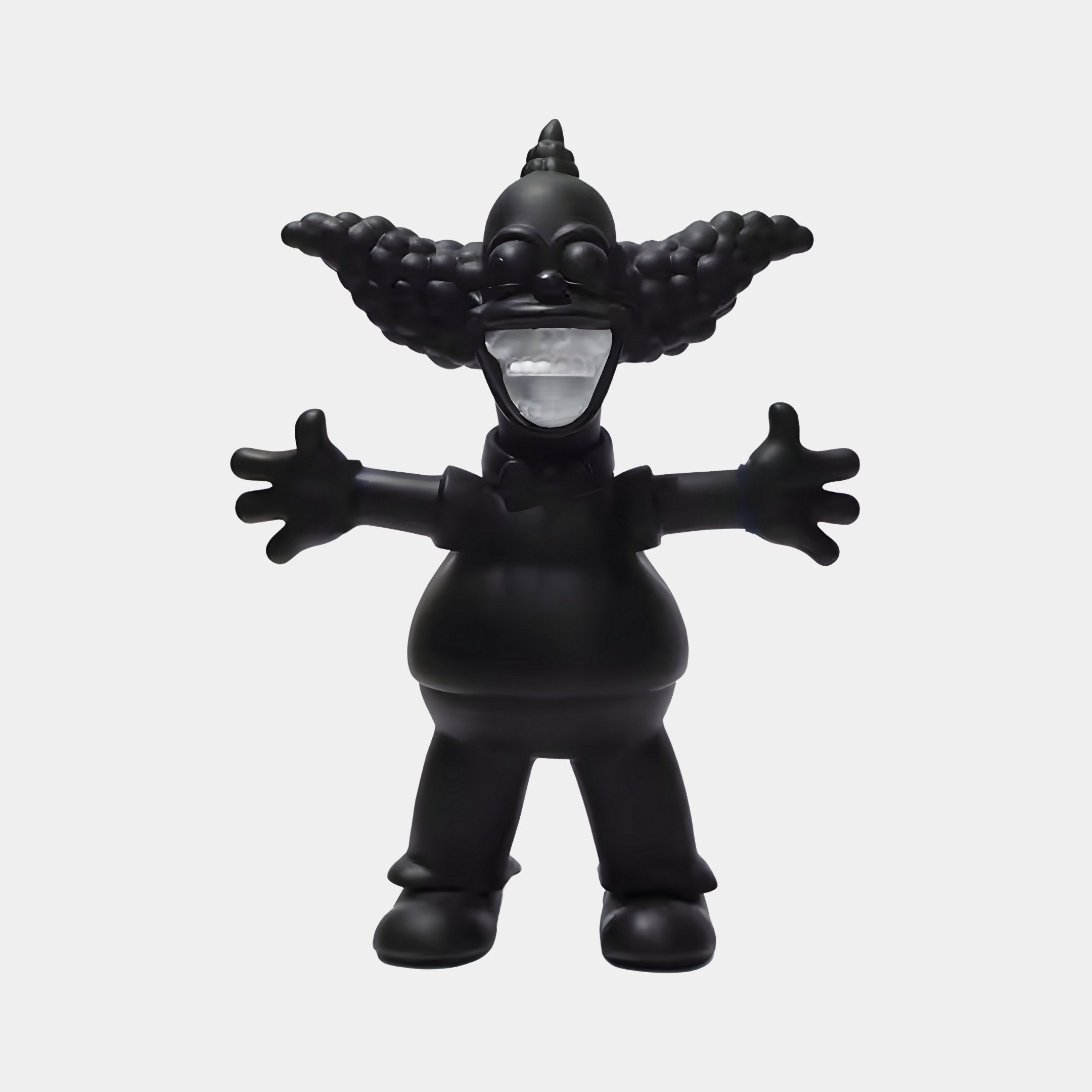 The Obsidian Black Iconify Chuckle Figure by Giant Sculptures, standing at 30cm, captures contemporary décor with a dramatic monochrome clown featuring wide, curly hair and an open-mouthed grin, blending cartoon charm with modern arts bold style.