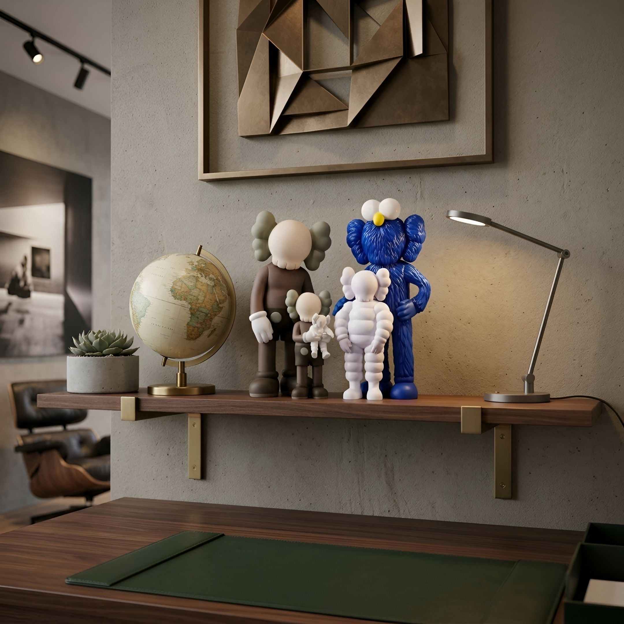 Iconify II All-Together Figure by Giant Sculptures, brown, white, and blue polyvinyl figures on a wood shelf with a globe and desk lamp in a study.