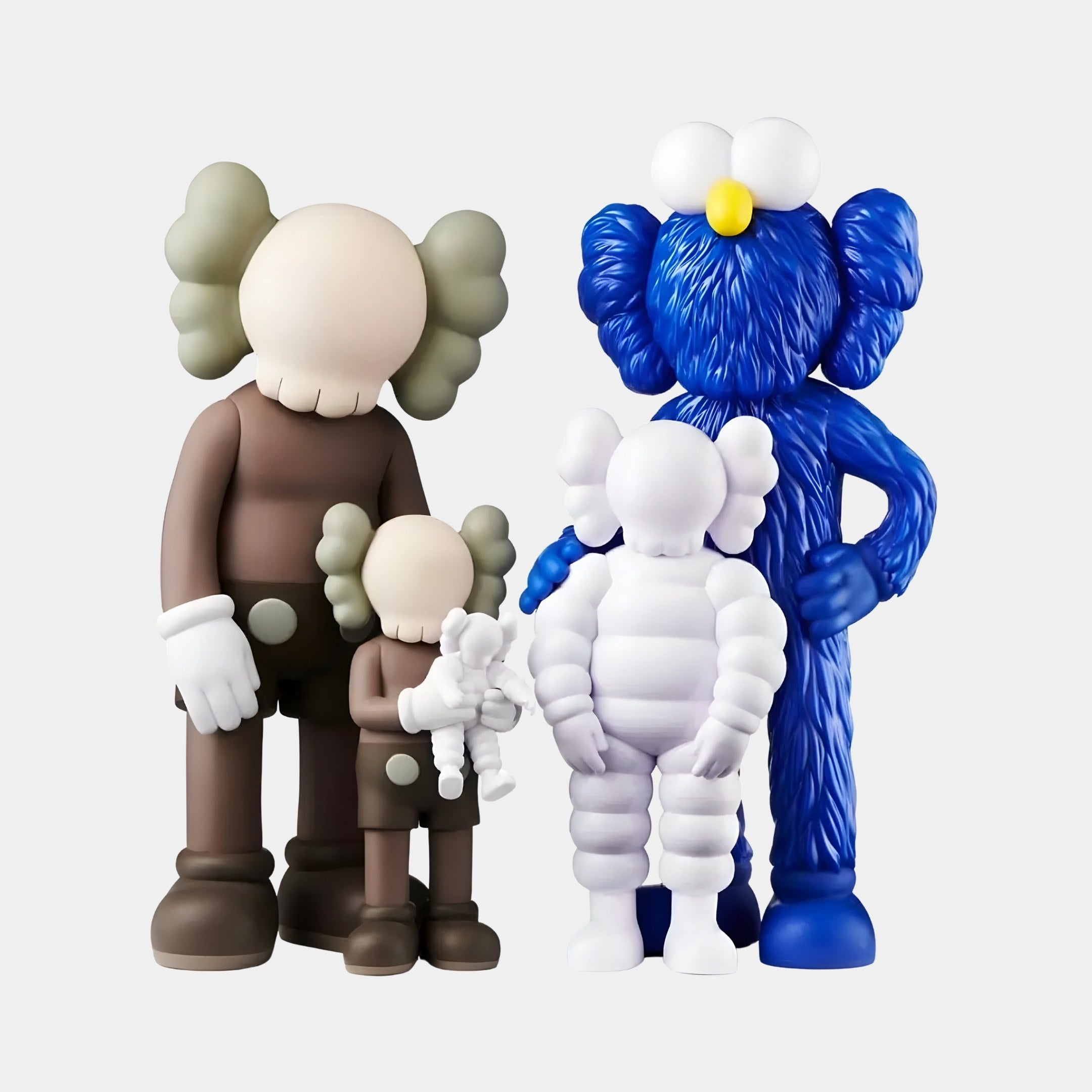 The Giant Sculptures Iconify II All-Together Figure features four stylized figures with cartoonish features: the tallest is brown with large white gloves, another smaller brown figure, a furry blue one on the right, and a small white figure in front—all with distinctive X-shaped eyes.