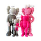 The Iconify III All-Together Figure by Giant Sculptures features two gray resin sculptures holding smaller figures—one pink, one gray—and a tall pink figure with white eyes. Heights range from 20 cm to 33 cm, celebrating togetherness in diversity for contemporary interiors.