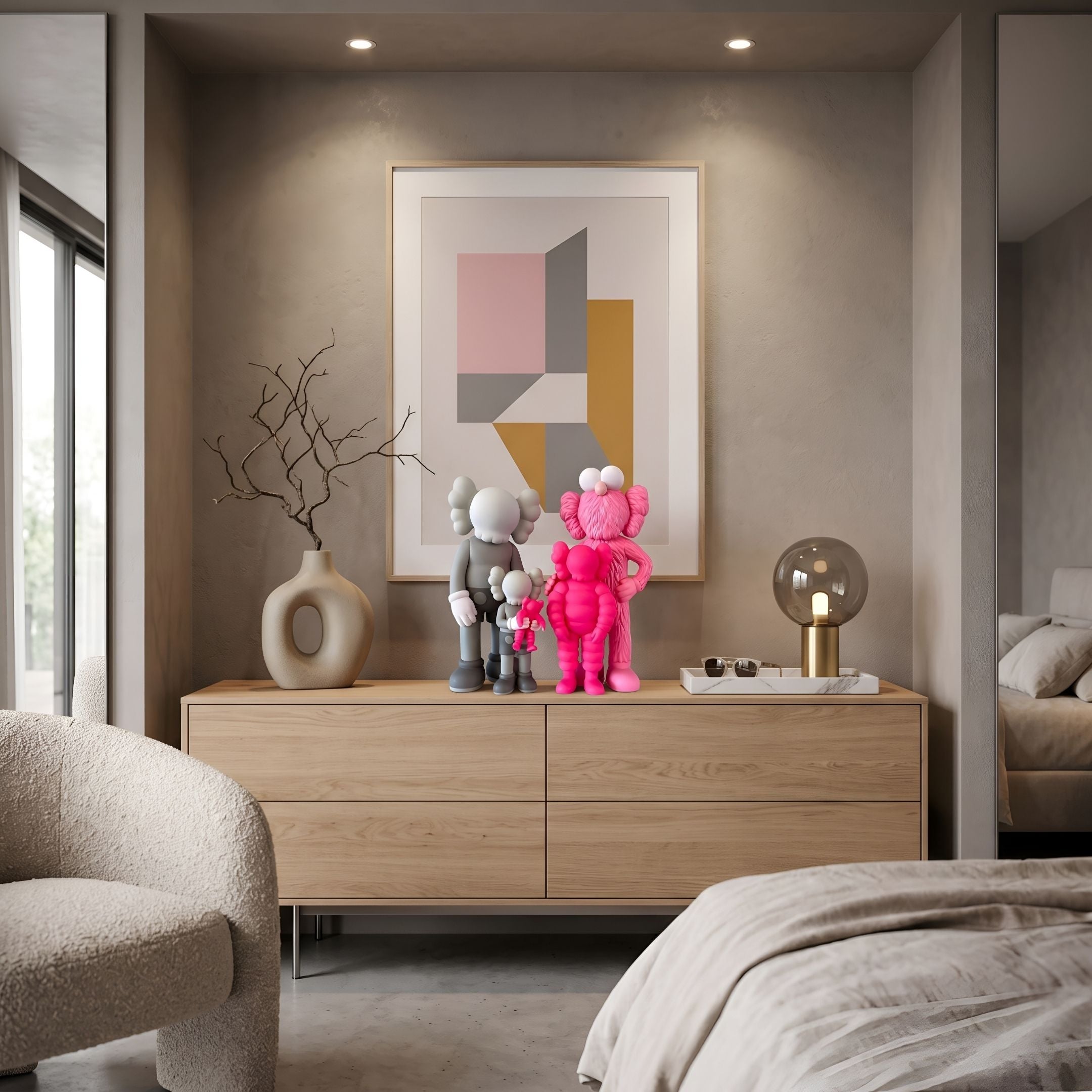 Iconify III All-Together Figure by Giant Sculptures, grey and pink cartoon-style figure grouping with X-mark eyes, displayed on a wooden dresser in a bedroom setting.