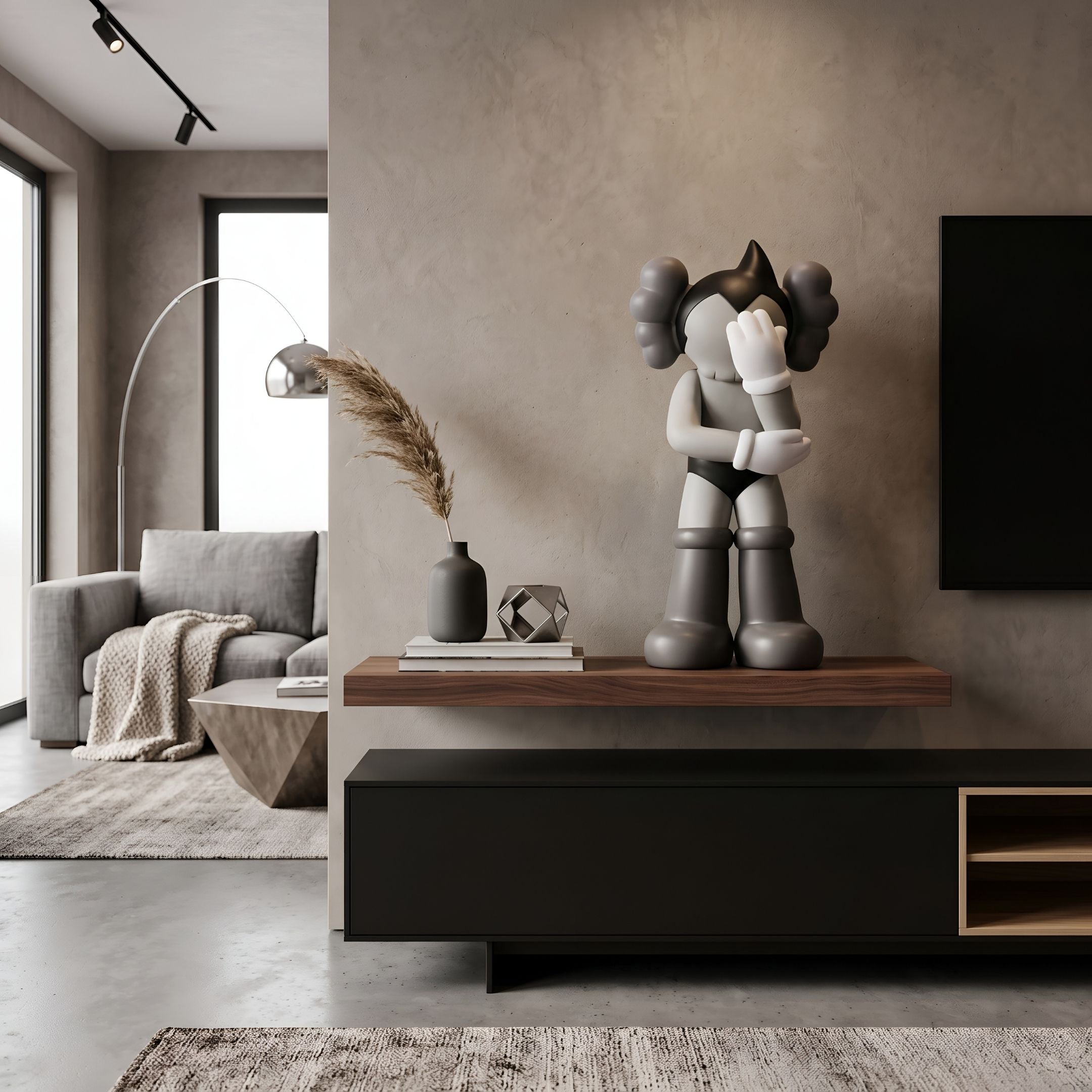 Slate Grey Iconify Cosmic Boy Figure, 37cm, displayed on a walnut floating shelf above a black media console in a living room with a grey sofa and floor lamp.