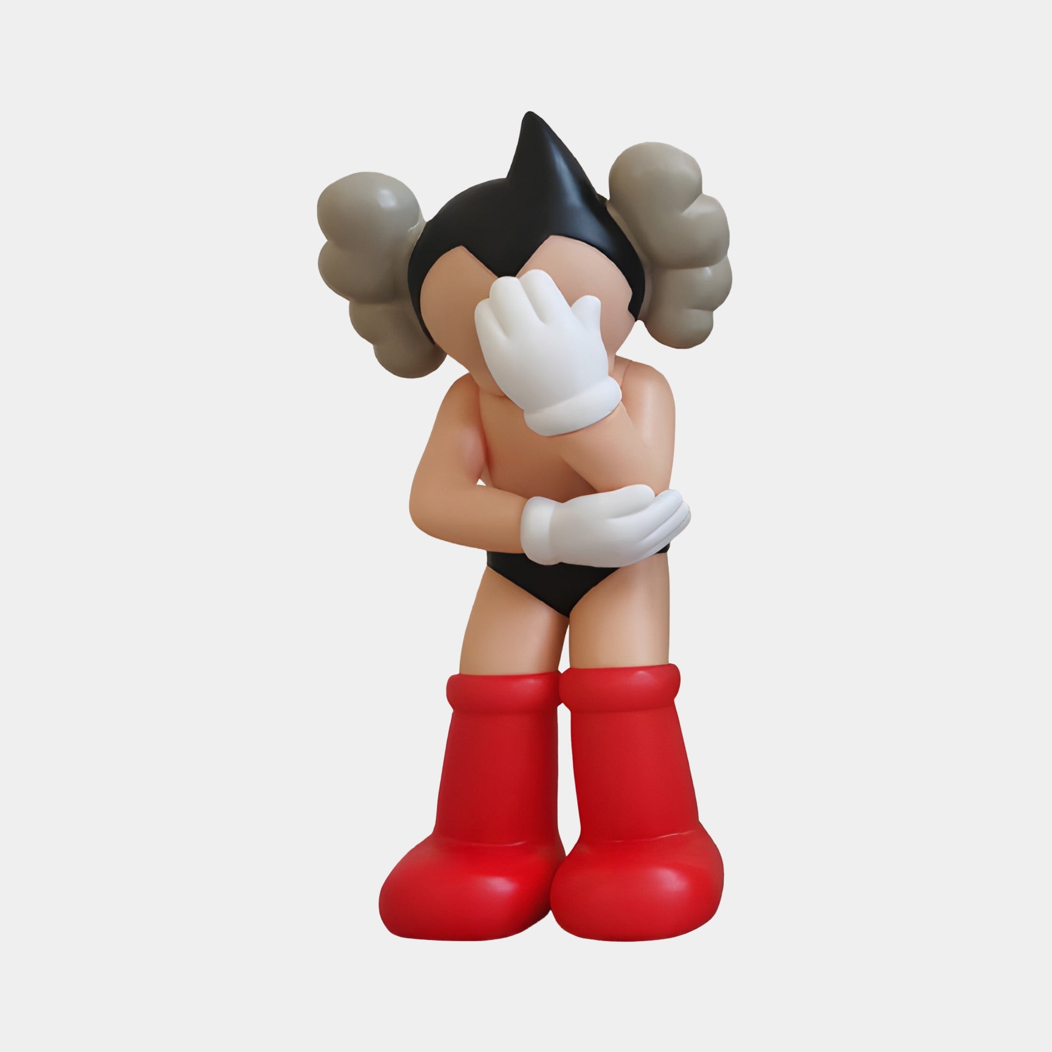 The Fiery Red I Iconify Cosmic Boy Figure by Giant Sculptures, standing 37cm tall, artfully features a cartoon character with spiky hair hidden beneath large white gloves, striking in big red boots and a black outfit against a pristine white backdrop.