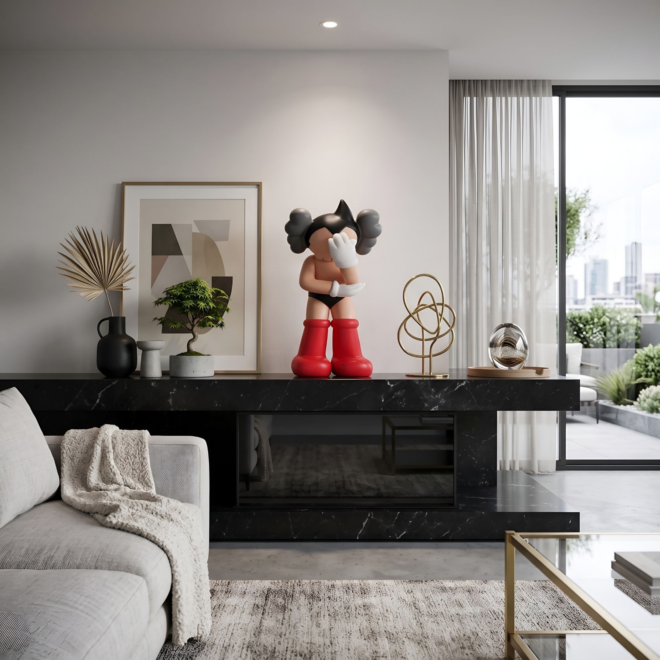 Fiery Red II Iconify Cosmic Boy Figure, 37cm, on a black marble sideboard with framed art and decor in a modern living room.