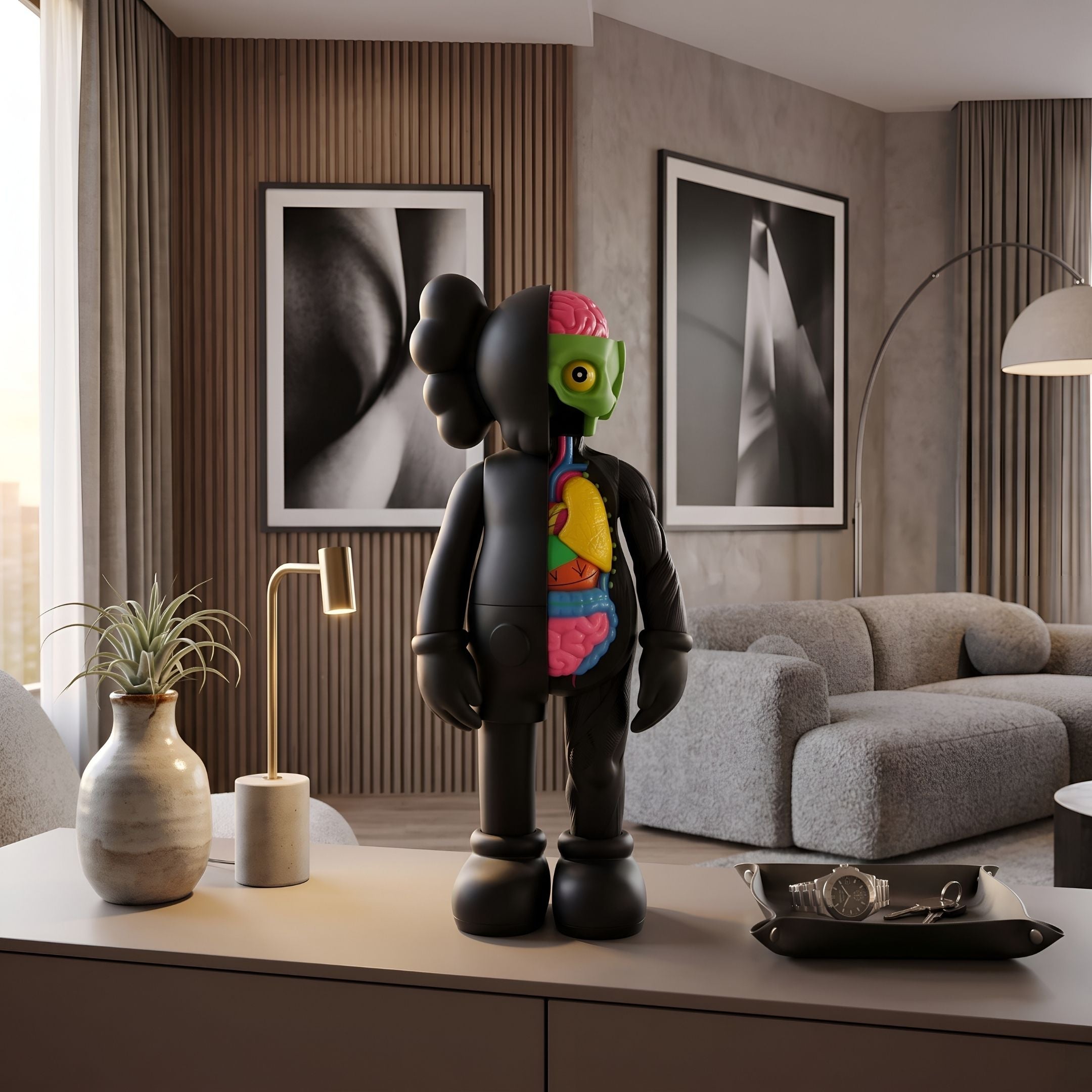 Midnight Black Iconify Anatomy Figure - 37cm on a living room console, black half-body with exposed organs and green skull, near a sofa and framed wall art.