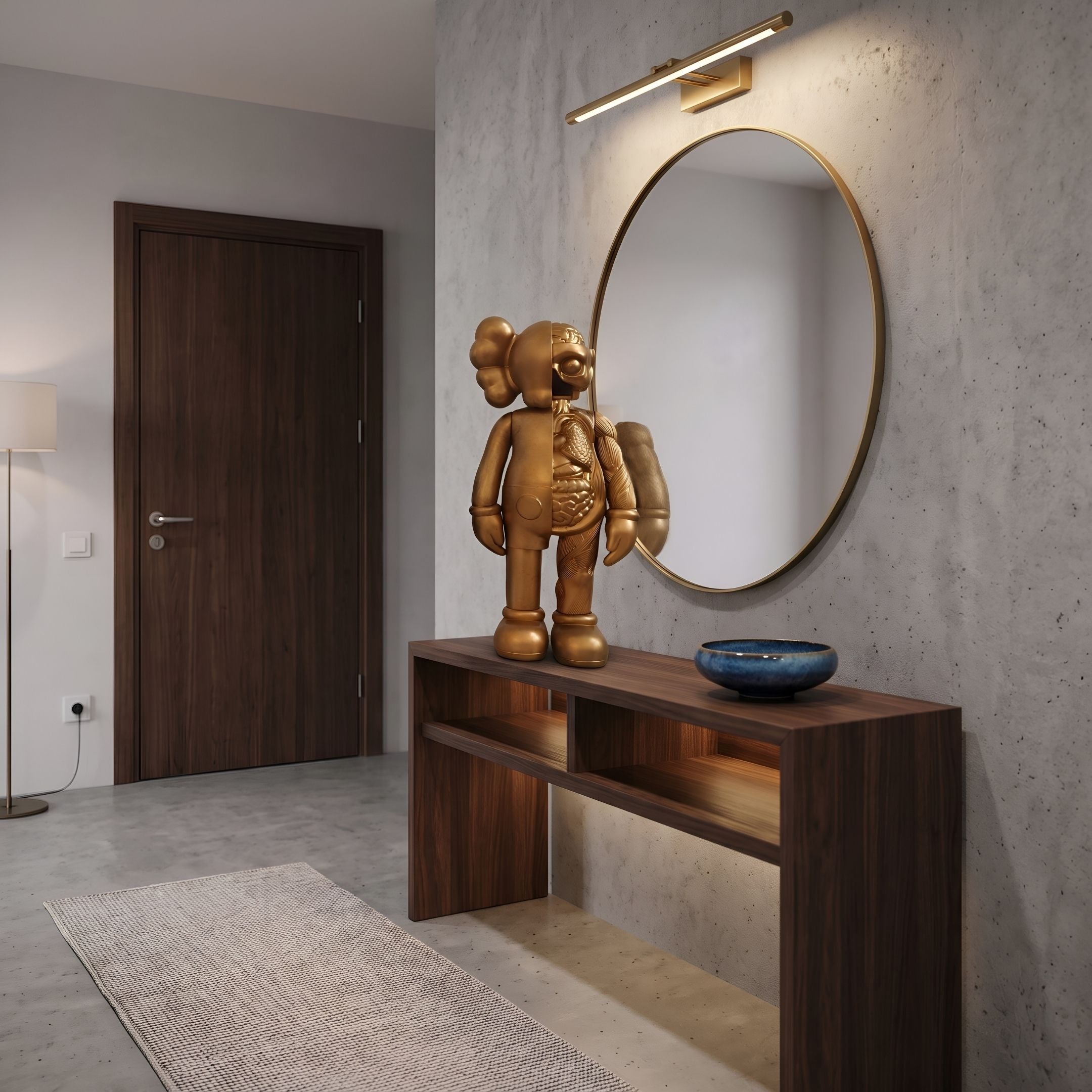 Antique Brushed Gold Iconify Anatomy Figure, 37cm, displayed on a wooden console table beneath a round mirror in an entryway setting.