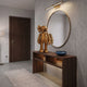 Antique Brushed Gold Iconify Anatomy Figure, 37cm, displayed on a wooden console table beneath a round mirror in an entryway setting.