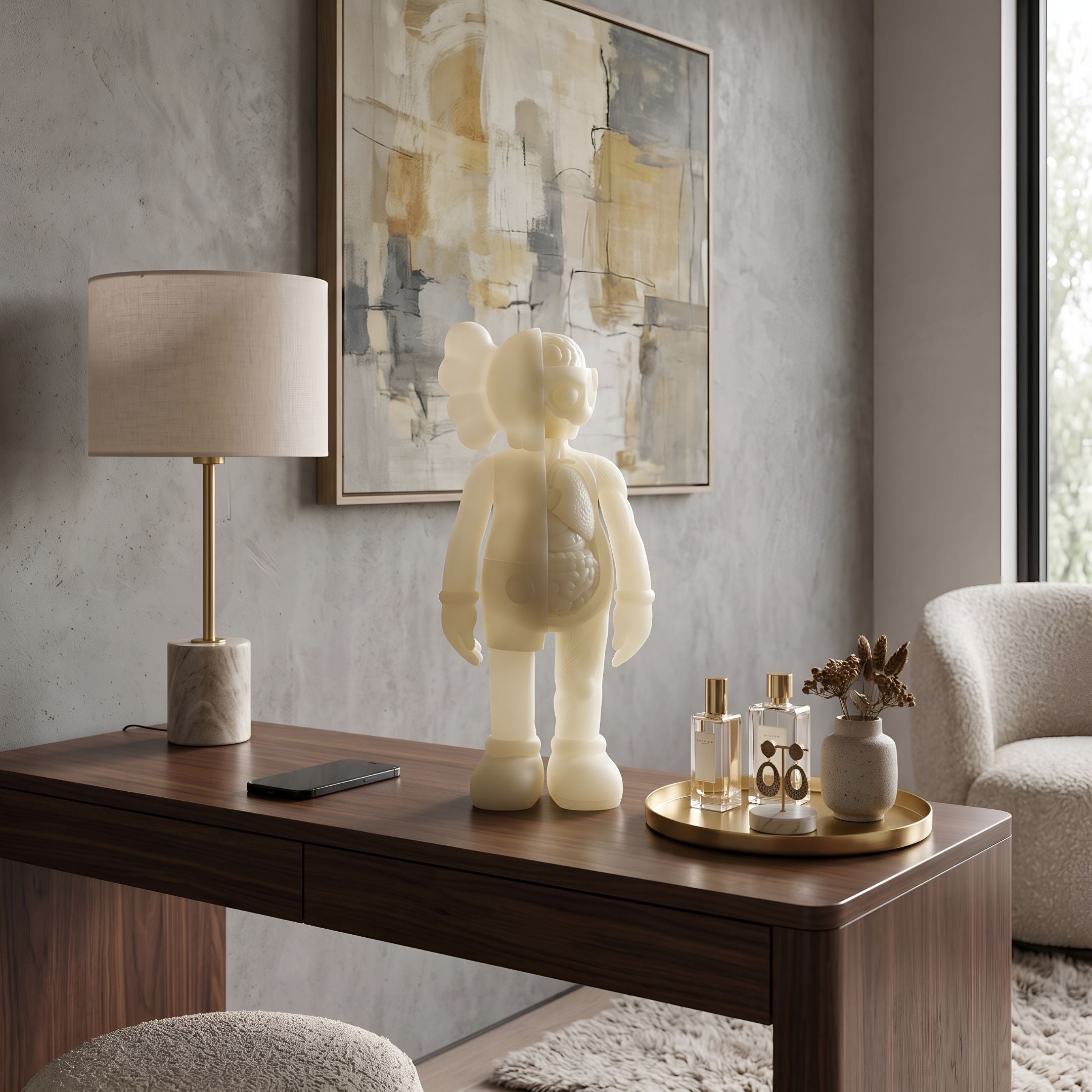 Ivory Iconify Anatomy Figure - 37cm, a standing character sculpture with visible anatomical cross-section, displayed on a wooden desk beside a lamp and abstract wall art.