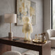 Ivory Iconify Anatomy Figure - 37cm, a standing character sculpture with visible anatomical cross-section, displayed on a wooden desk beside a lamp and abstract wall art.