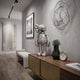 Titanium Slate Iconify Anatomy Figure, 37cm silver anatomical designer sculpture, displayed on a wooden sideboard in a modern hallway with wall art.