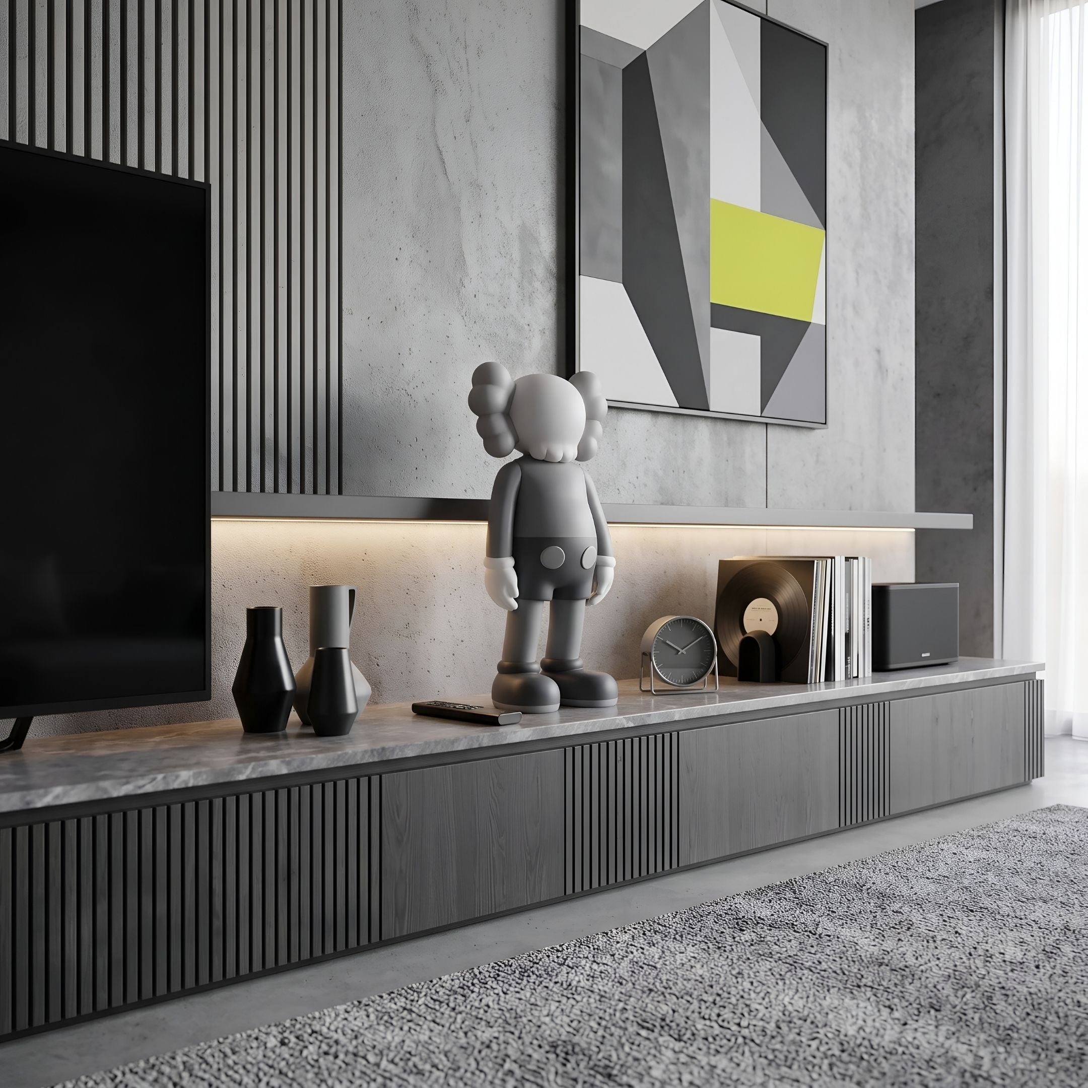 Soft Grey Iconify Standing Figure - 37cm displayed on a TV console shelf with vases, a clock, and vinyl records in a grey living room.