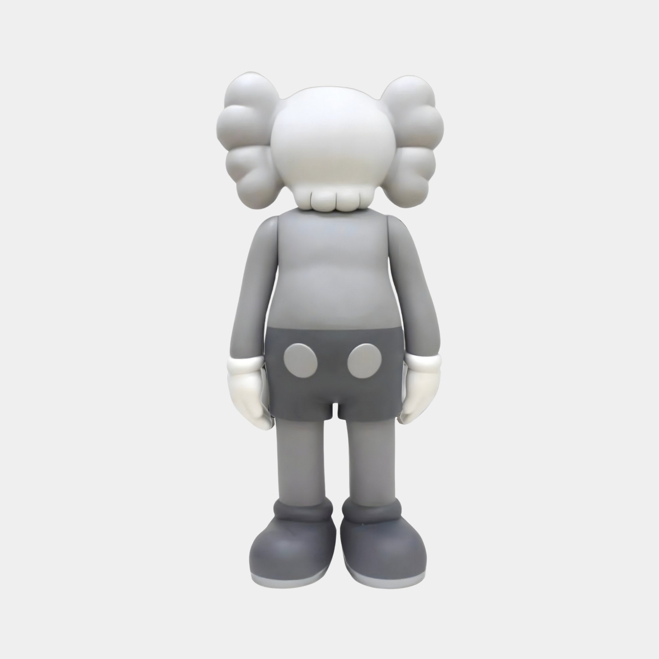 The Soft Grey Iconify Standing Figure - 37cm by Giant Sculptures is a resin statue with a cartoon-like design, featuring puffy ears, white gloves, large shoes, and dotted shorts. Its minimalistic and featureless face adds both whimsy and contemporary style to any décor.