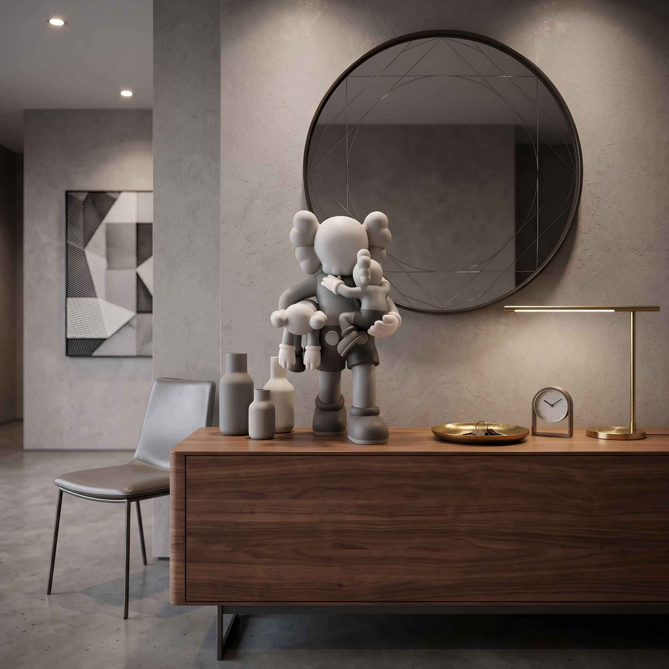 Soft Grey Iconify Family Figure - 38cm, X-eyed parent figure holding two smaller figures, on a walnut sideboard beside vases, a clock, and a round mirror.