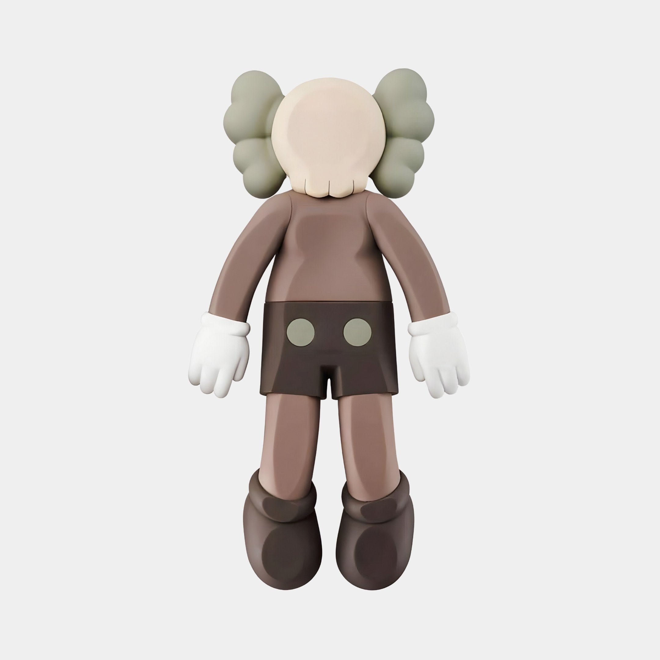 The 38cm Hazelnut Brown Iconify Flat Figure by Giant Sculptures is a cartoon-like character with a round, featureless face, gray crossed gloves, and shoes. It sports dark shorts with two buttons and features X-shaped eyes with puffy gray ears, perfect for contemporary interiors.