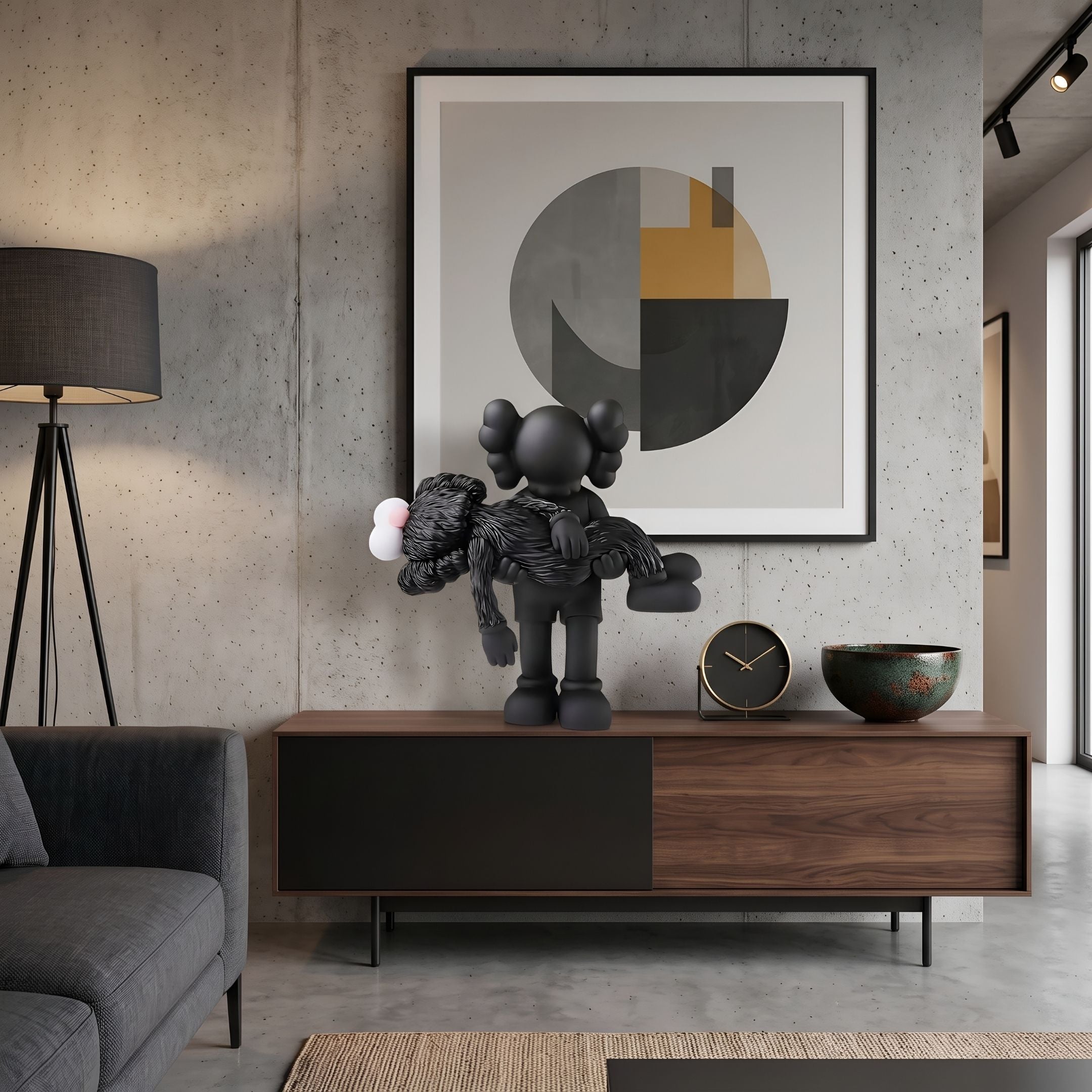 Obsidian Black Iconify Rescuing Figure, 38cm polyvinyl sculpture cradling a furry companion, displayed on a walnut sideboard beside a clock and bowl in a modern living room.