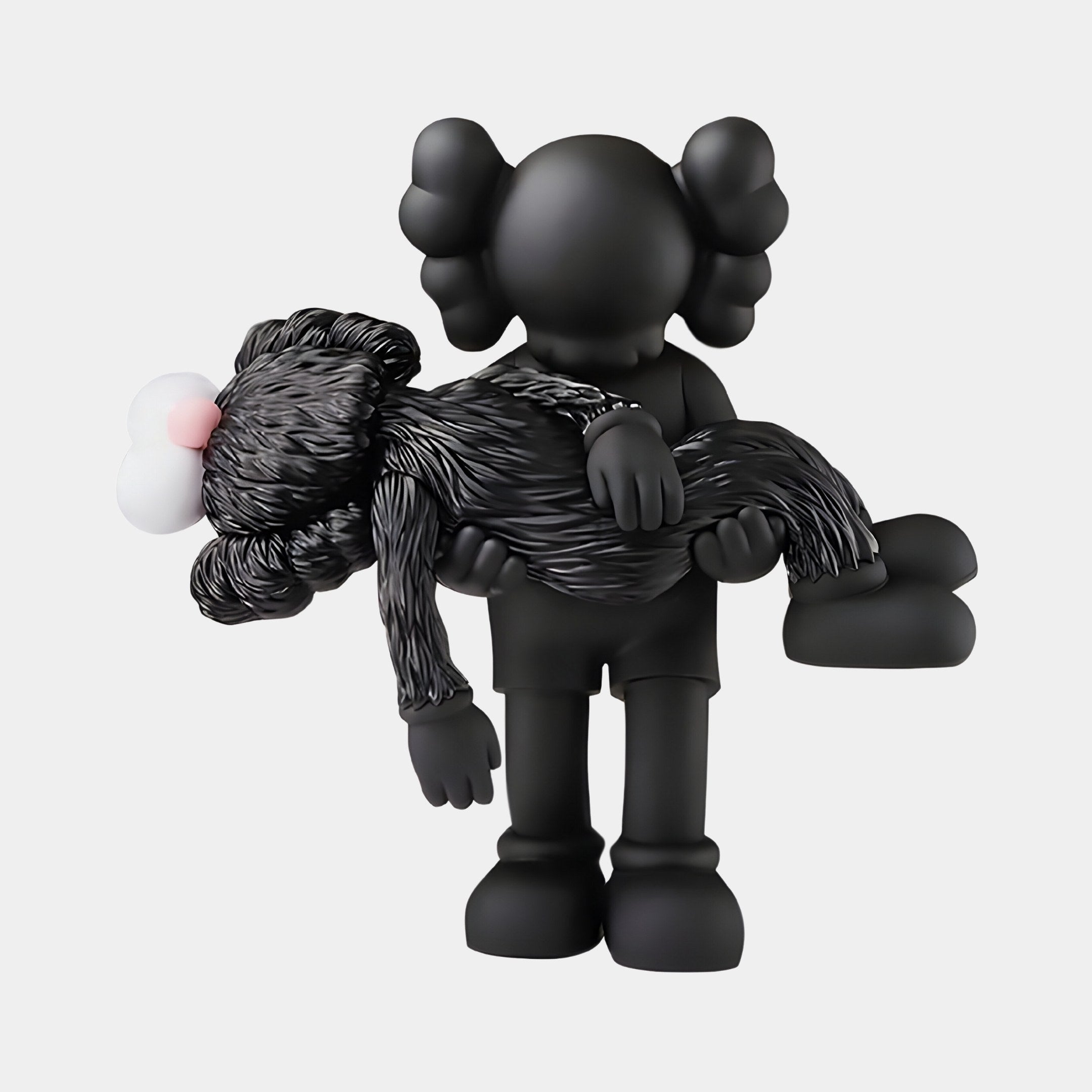 The Obsidian Black Iconify Rescuing Figure by Giant Sculptures features a stylized black figurine with distinct eyes and ears, holding a limp furry figure against a white background, evoking contemporary interiors.