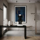 Obsidian Black Iconify Furry Sitting Figure, 40cm, on a white pedestal in an entryway with a black console table and abstract blue wall art.