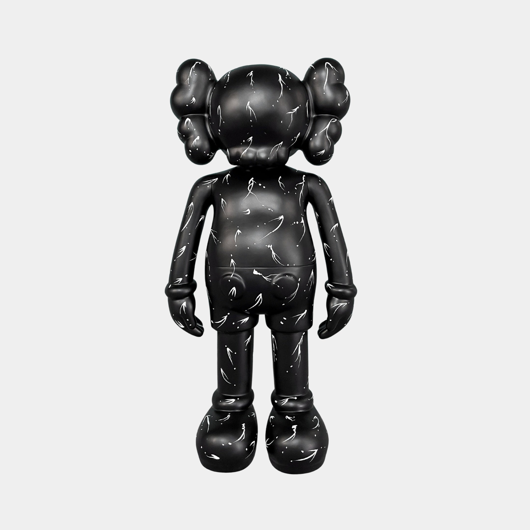 The Black Stone Iconify Standing Sculpture (70cm) by Giant Sculptures features a black cartoon-style figure with round ears, gloved hands, large shoes, and white scratch-like marks, standing upright on a plain light background—a bold statement décor piece.