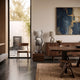Soft Grey Iconify I Dance Sculpture, 70cm, standing on a wood plinth in a dining area with a walnut table, sideboard, and abstract blue artwork.