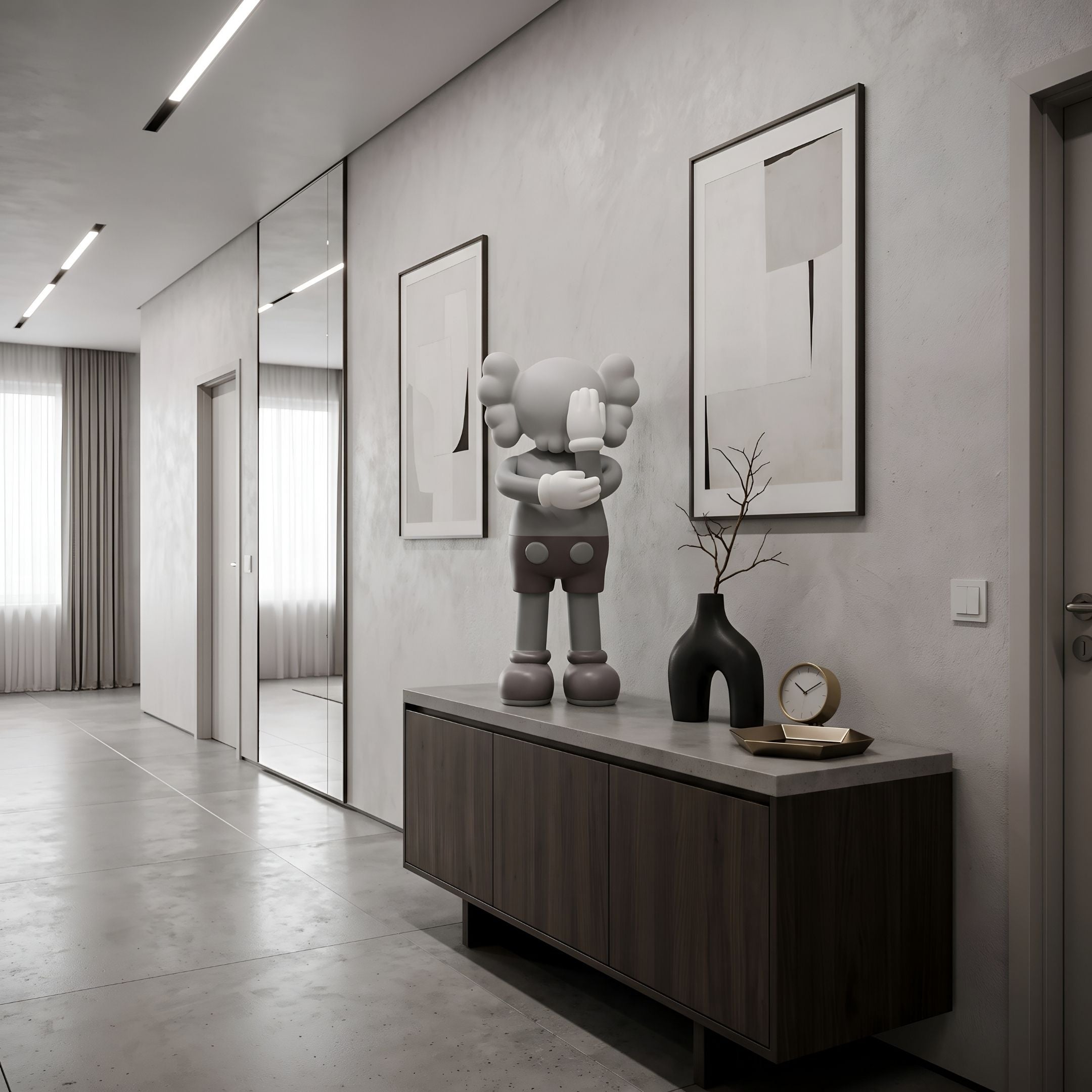 Soft Grey Iconify IV Dance Sculpture, 70cm resin figure with crossed arms, on a wooden sideboard in a modern hallway with framed wall art.