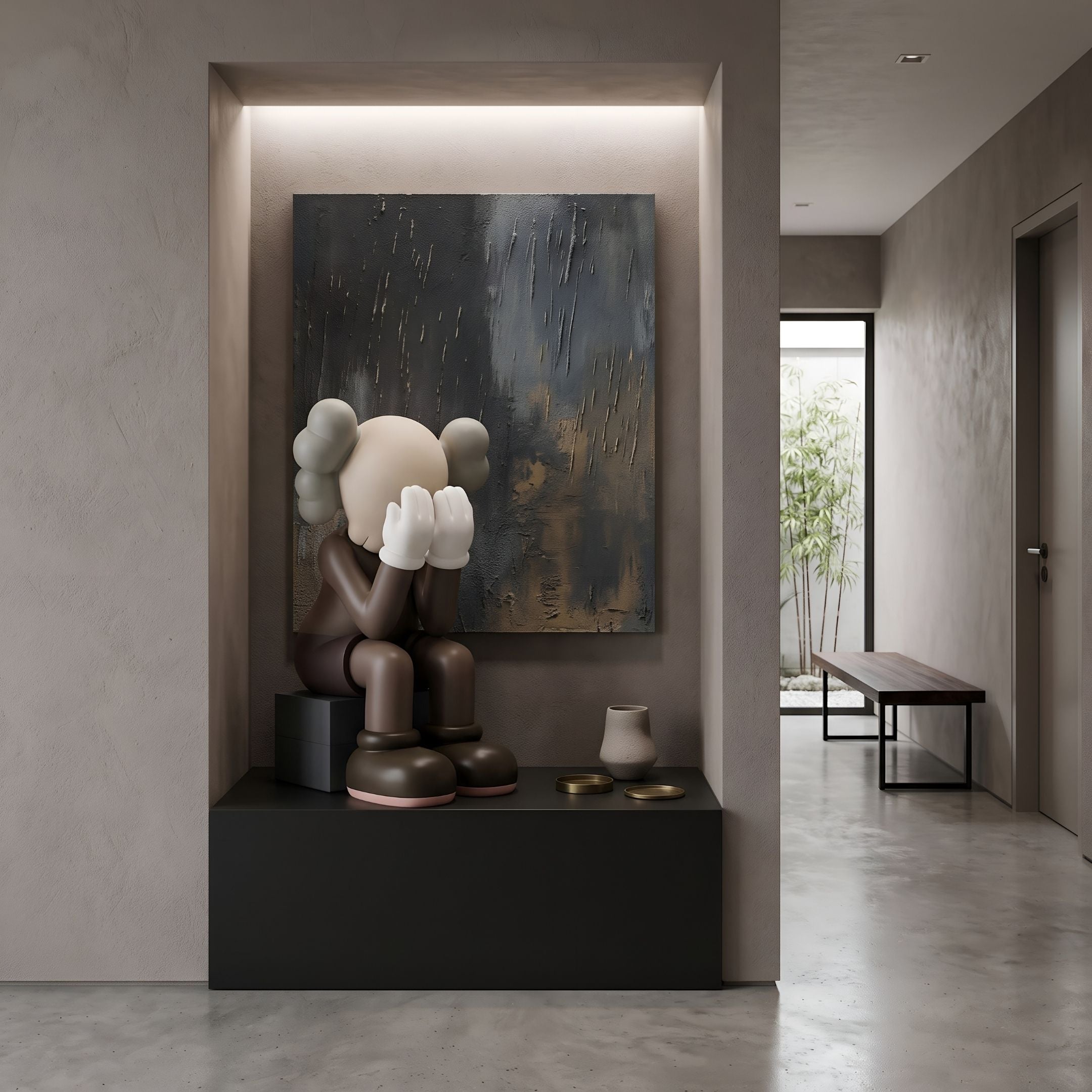 Hazelnut Brown Iconify Melancholy Sitting Sculpture, 70cm resin figure with hands covering face, displayed on a black block base in a hallway niche beneath abstract wall art.