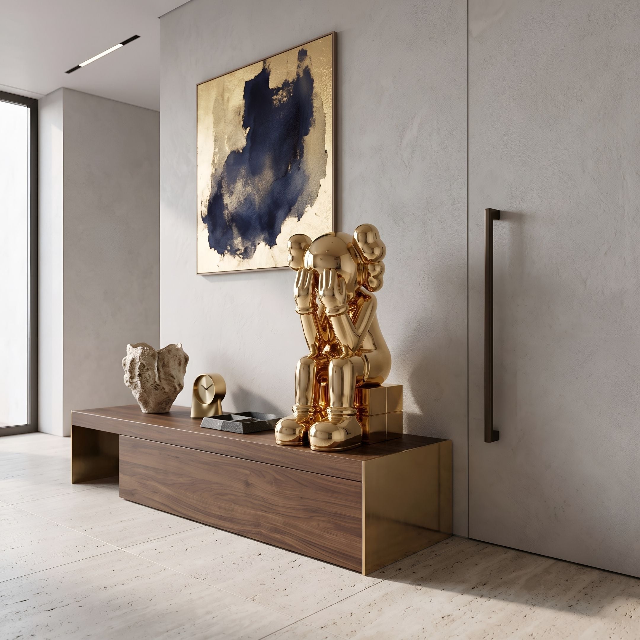Antique Gold Iconify Melancholy Sitting Sculpture, 70cm, seated resin figure with hands covering its face, displayed on a walnut console beneath abstract wall art.
