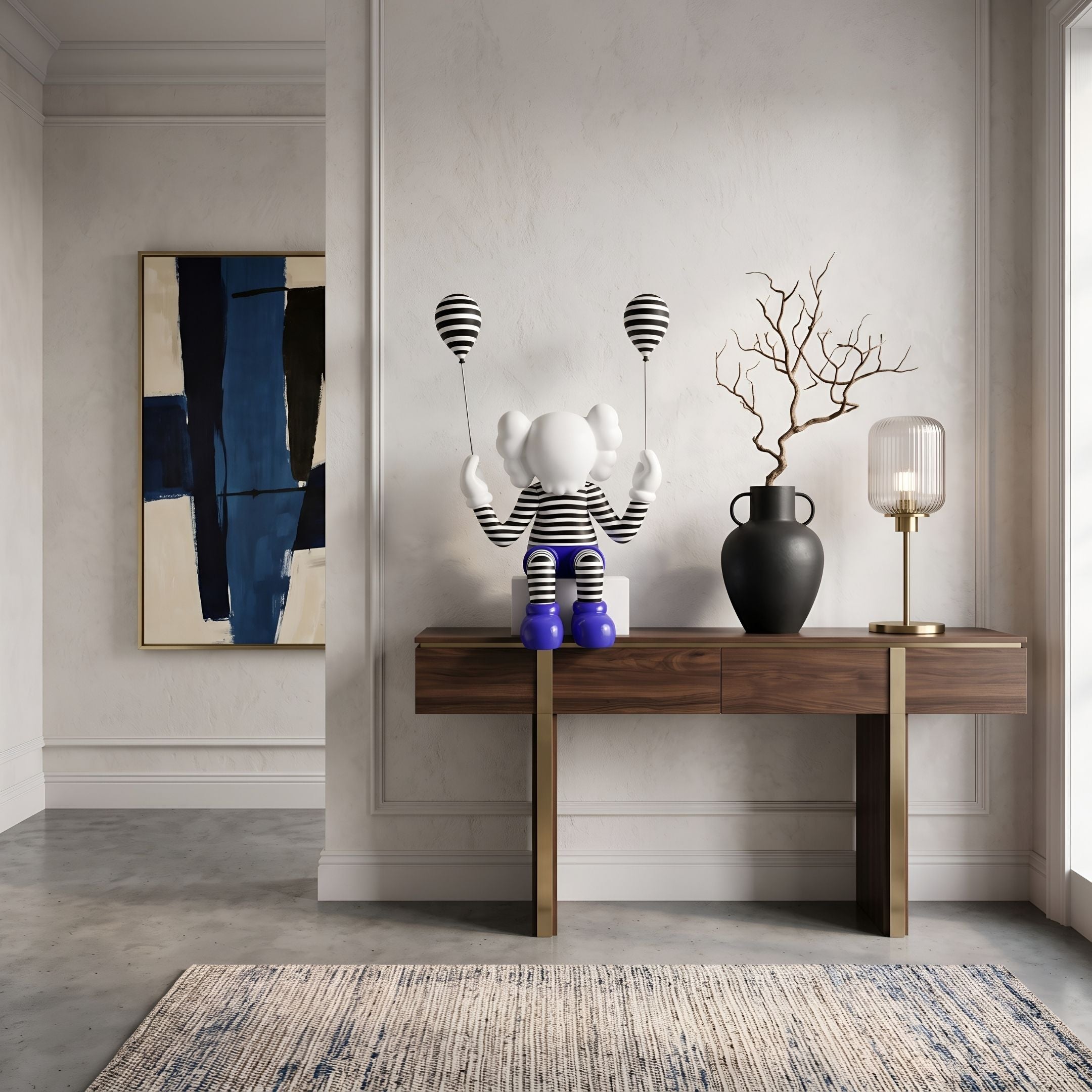 Deep Blue Iconify Mime Sitting Sculpture, 70cm, in black-and-white striped outfit with blue shoes and balloons, displayed on a console table in an entryway setting.