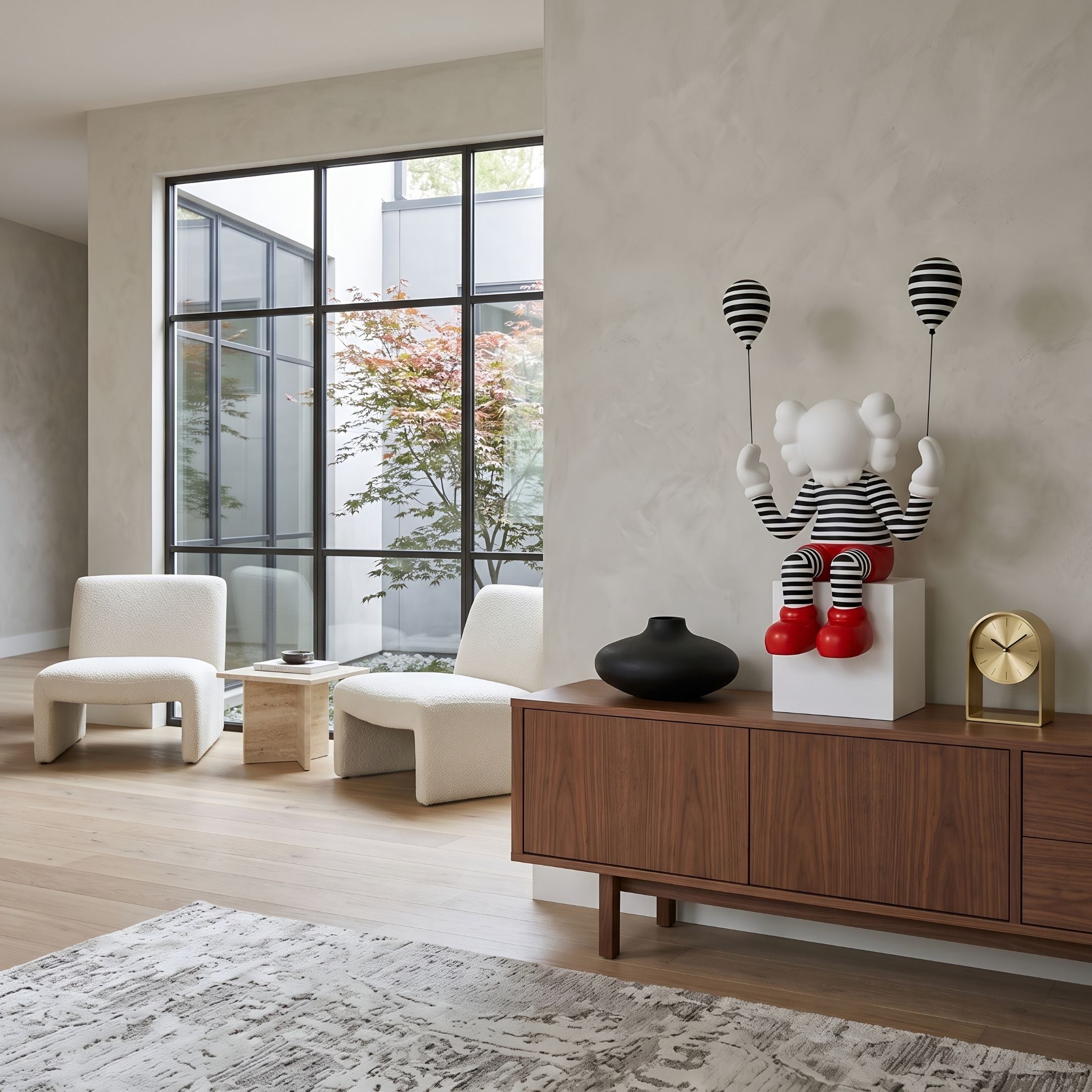 Lustrous Red Iconify Mime Sitting Sculpture, 70cm, striped figure with red shoes and balloons on a white pedestal atop a walnut sideboard in a living room.