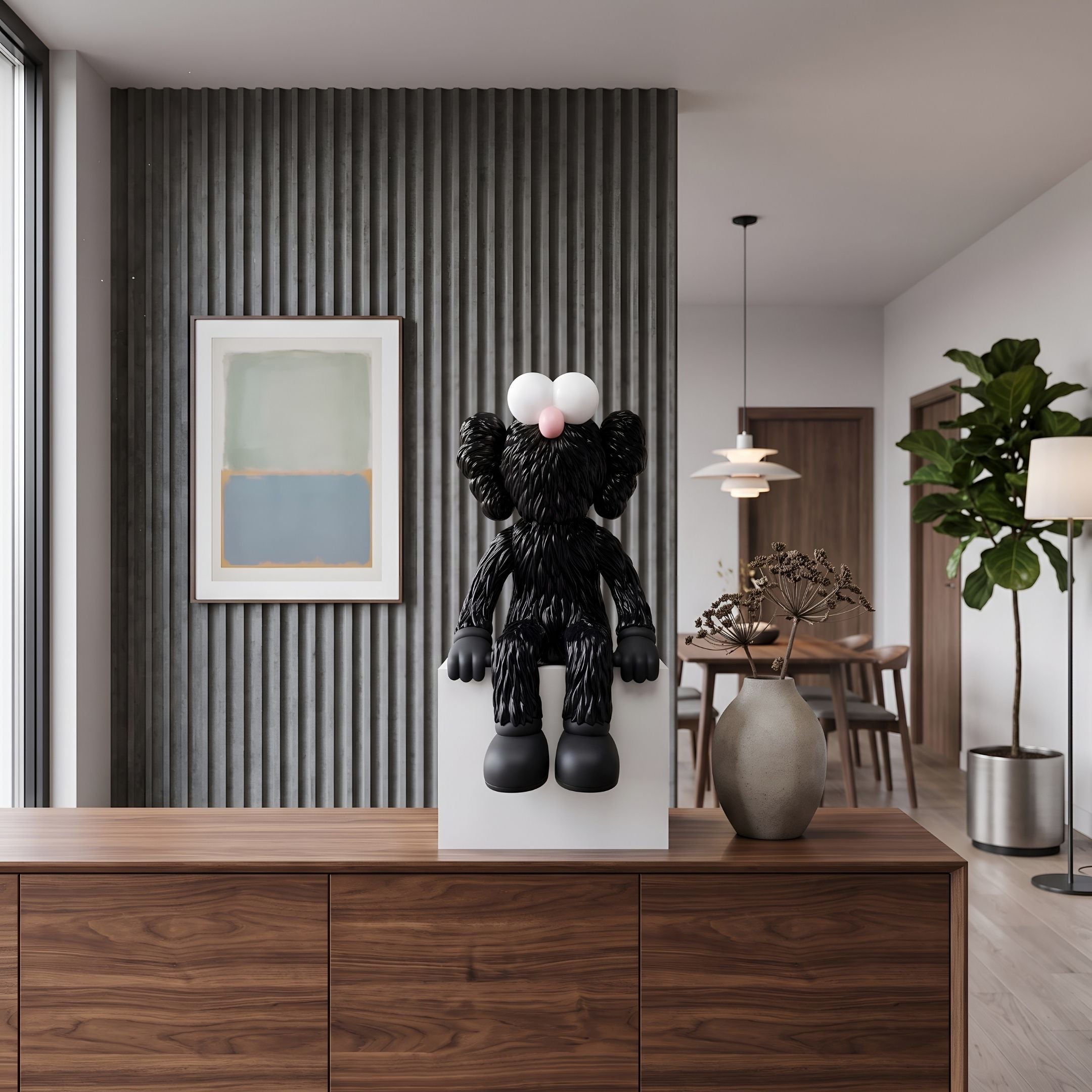 Obsidian Black Iconify Furry Sitting Sculpture, 70cm, on a white plinth atop a wooden sideboard in a living room with wall art and a pendant light.