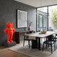 Fiery Orange Iconify Rollo Warrior Sculpture, 80cm, on a concrete base in a modern dining room beside a wood console table and abstract wall art.