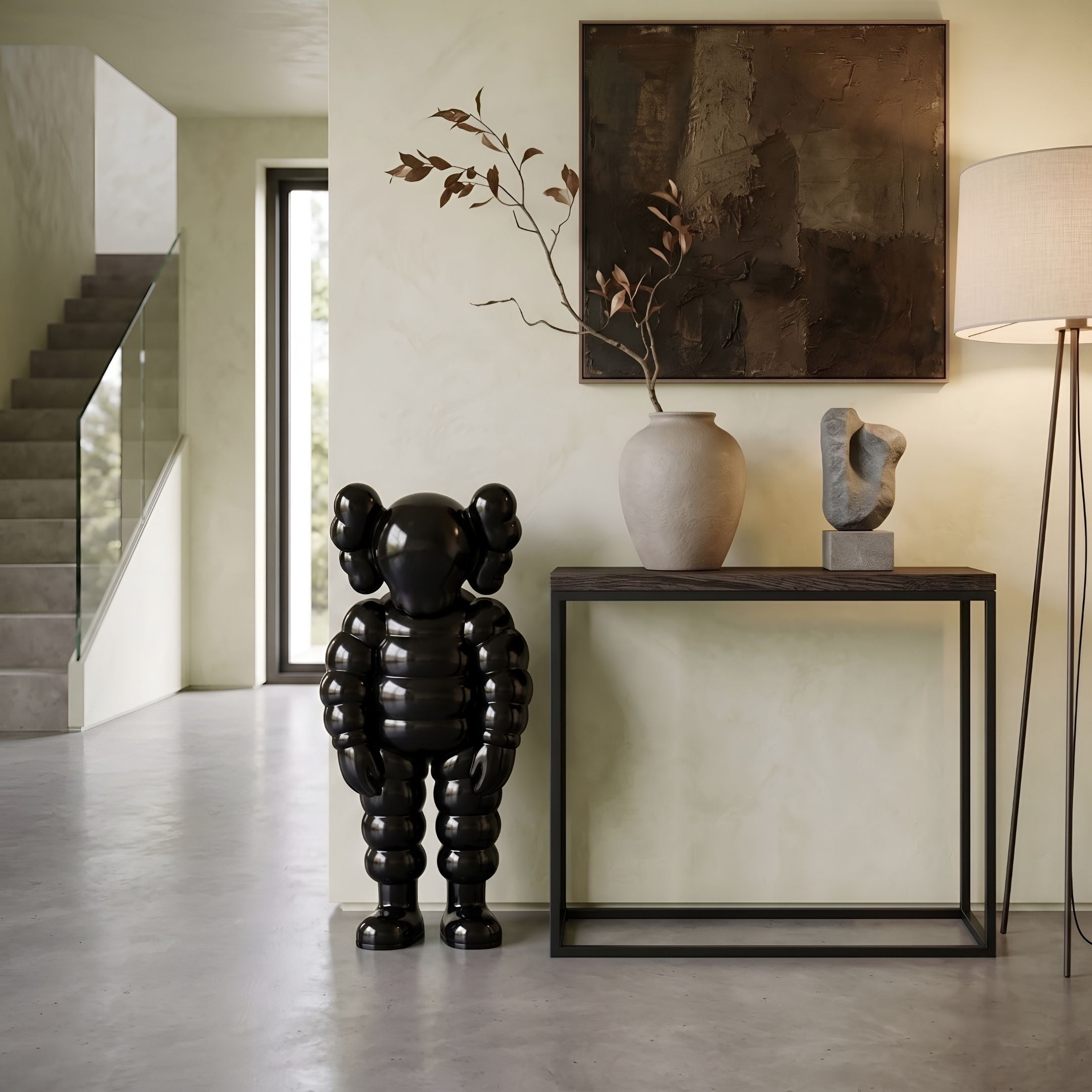 Midnight Black Iconify Rollo Sculpture, 80cm glossy black figure with rounded limbs, displayed on entryway floor beside a dark console table.
