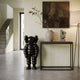 Midnight Black Iconify Rollo Sculpture, 80cm glossy black figure with rounded limbs, displayed on entryway floor beside a dark console table.