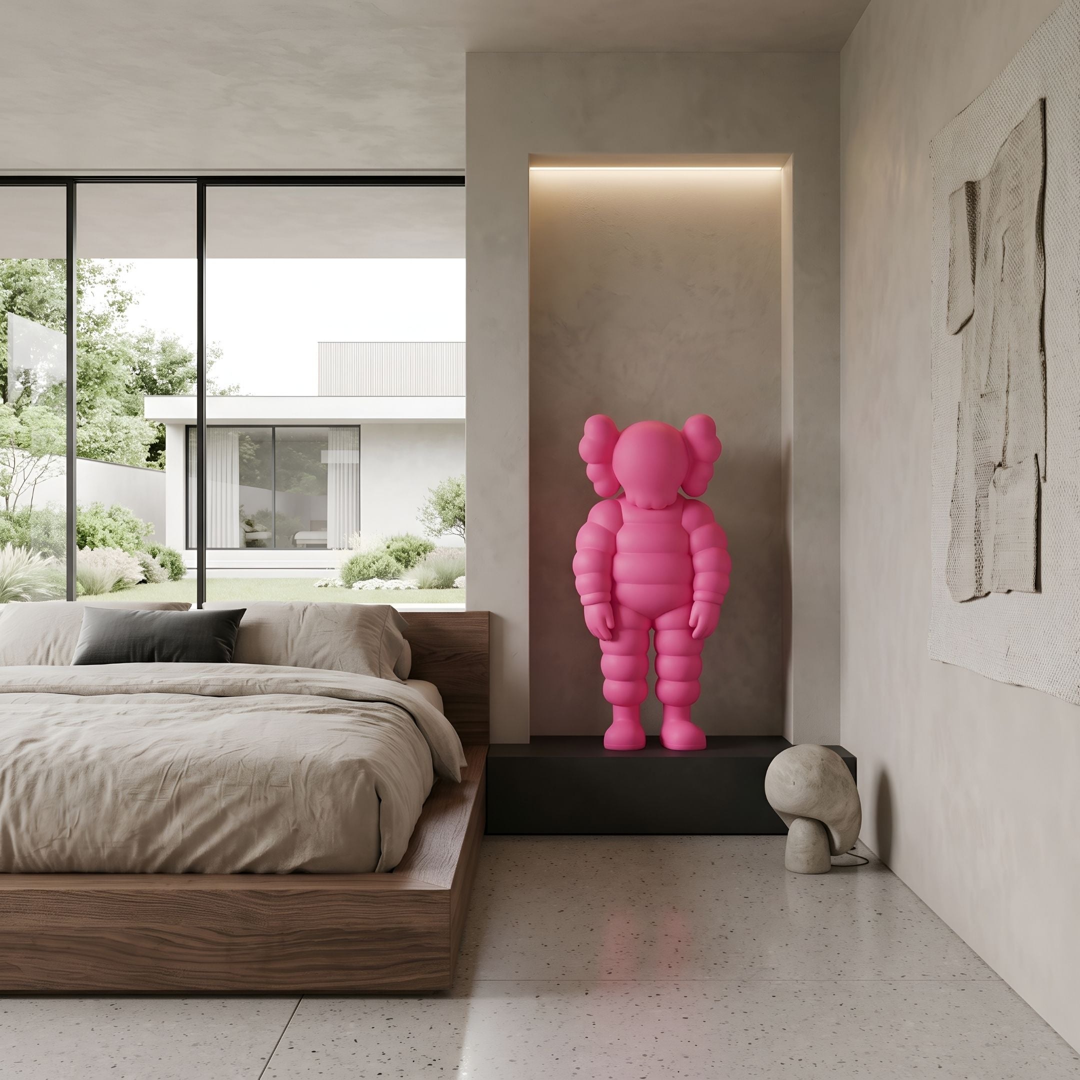 Electric Pink Iconify Rollo Sculpture, 80cm, displayed on a black platform in an alcove within a bedroom with a wooden bed frame.