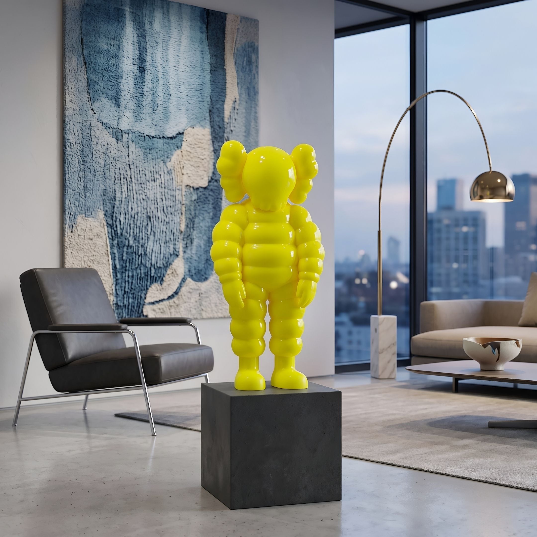 Citrus Yellow Iconify Rollo Sculpture (80cm) by Giant Sculptures on a dark plinth in a living room with a black armchair, arc floor lamp, and city-view windows.