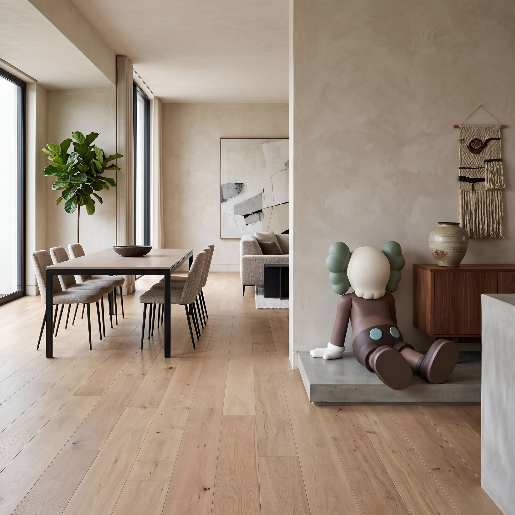 Hazelnut Brown Iconify Daydream Sculpture, 85cm, seated on a concrete platform beside a dining area with wood table, chairs, and fiddle-leaf fig plant.