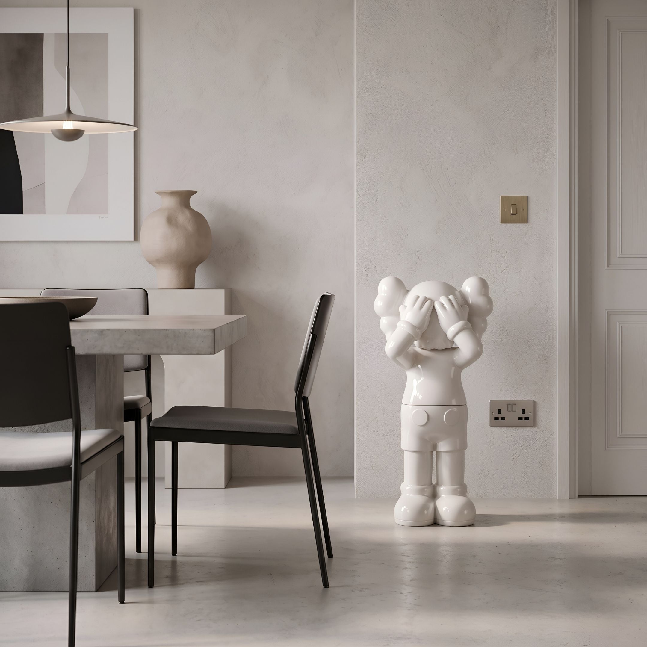Cloud White Iconify Silent Cry Sculpture, 91cm, glossy white figure covering its face, displayed in a neutral dining room with dark chairs and a stone table.